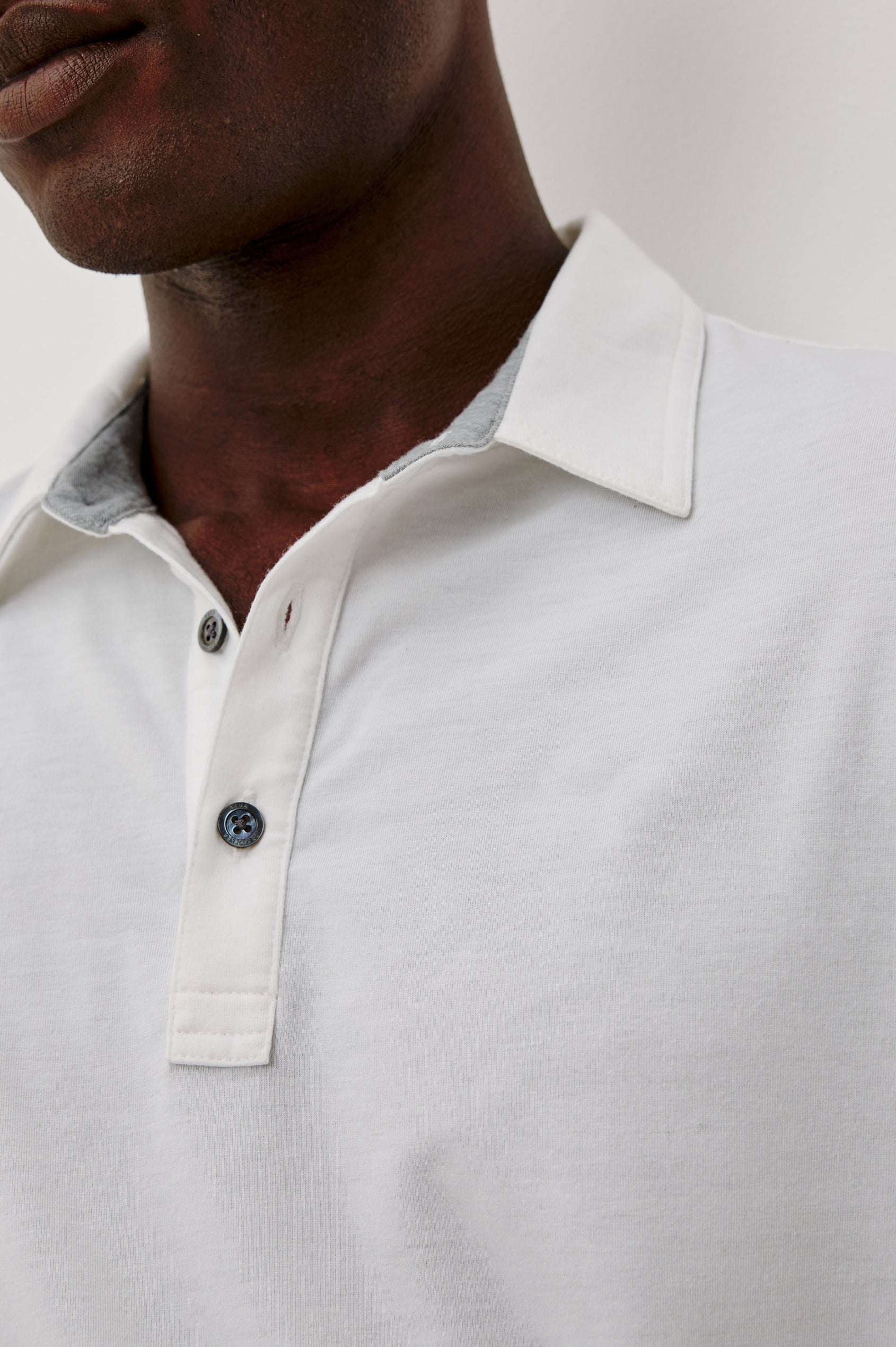Merced Golf Polo in TENCEL™-Poly Stretch Blend With Moisture-Wicking Properties, Collar, Quarter-Placket, and Short Sleeves in White Colorway - Upper Body Close Up View Featured on Model