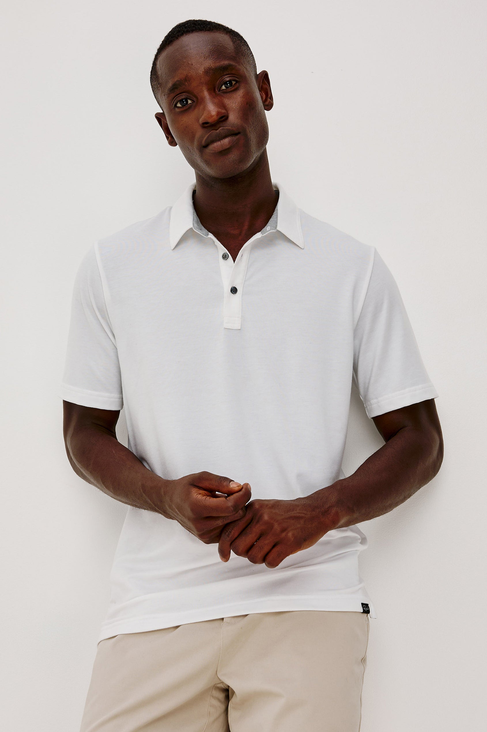 Merced Golf Polo in TENCEL™-Poly Stretch Blend With Moisture-Wicking Properties, Collar, Quarter-Placket, and Short Sleeves in White Colorway - Upper Body Front View Featured on Model