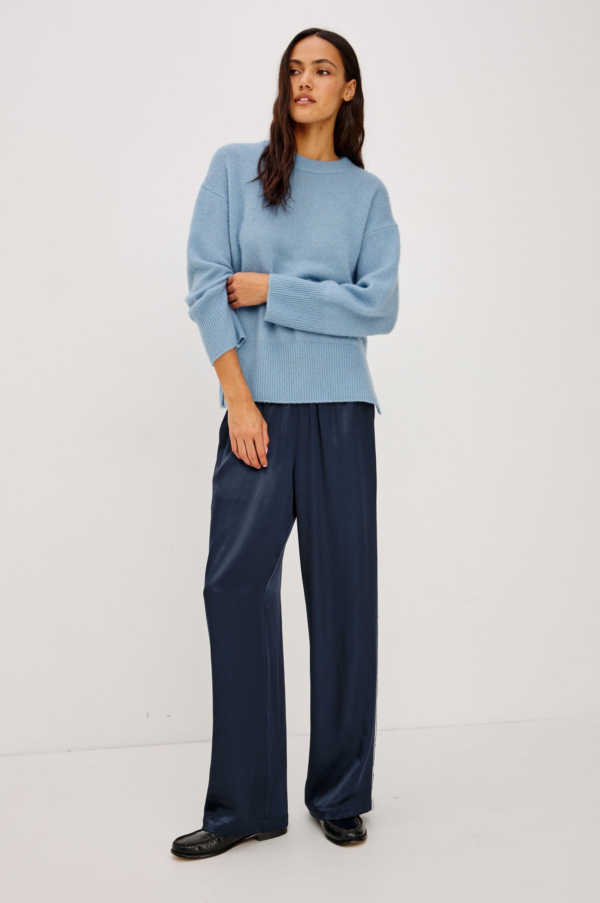 Merida Track Pant in Satin-Back Crepe With Elastic Waist, Side Slant Pockets, Wide Legs, and Contrast Side Stripes in Navy Colorway - Front Full Body View Featured on Model.