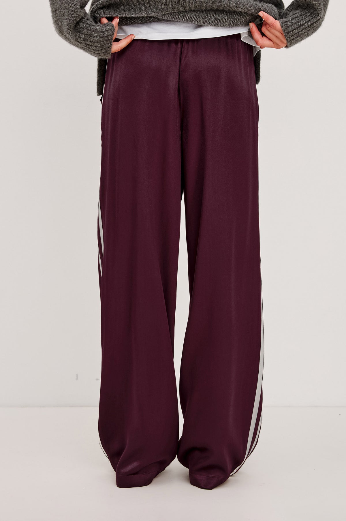 Merida Pant in Satin Back Crepe With Elastic Waistband, Side Pockets, and Wide Legs With Double Side Stripes in Wine Colorway - Lower Body Back View Featured on Model