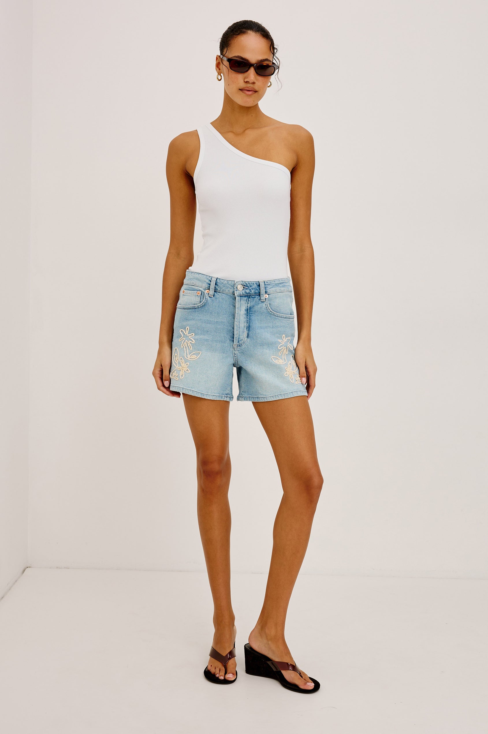 Mesa High-Rise Short in Light Stretch Denim With 5-Pockets and Button Fly in Floral Embroidery Colorway - Full Body Front View Featured on Model