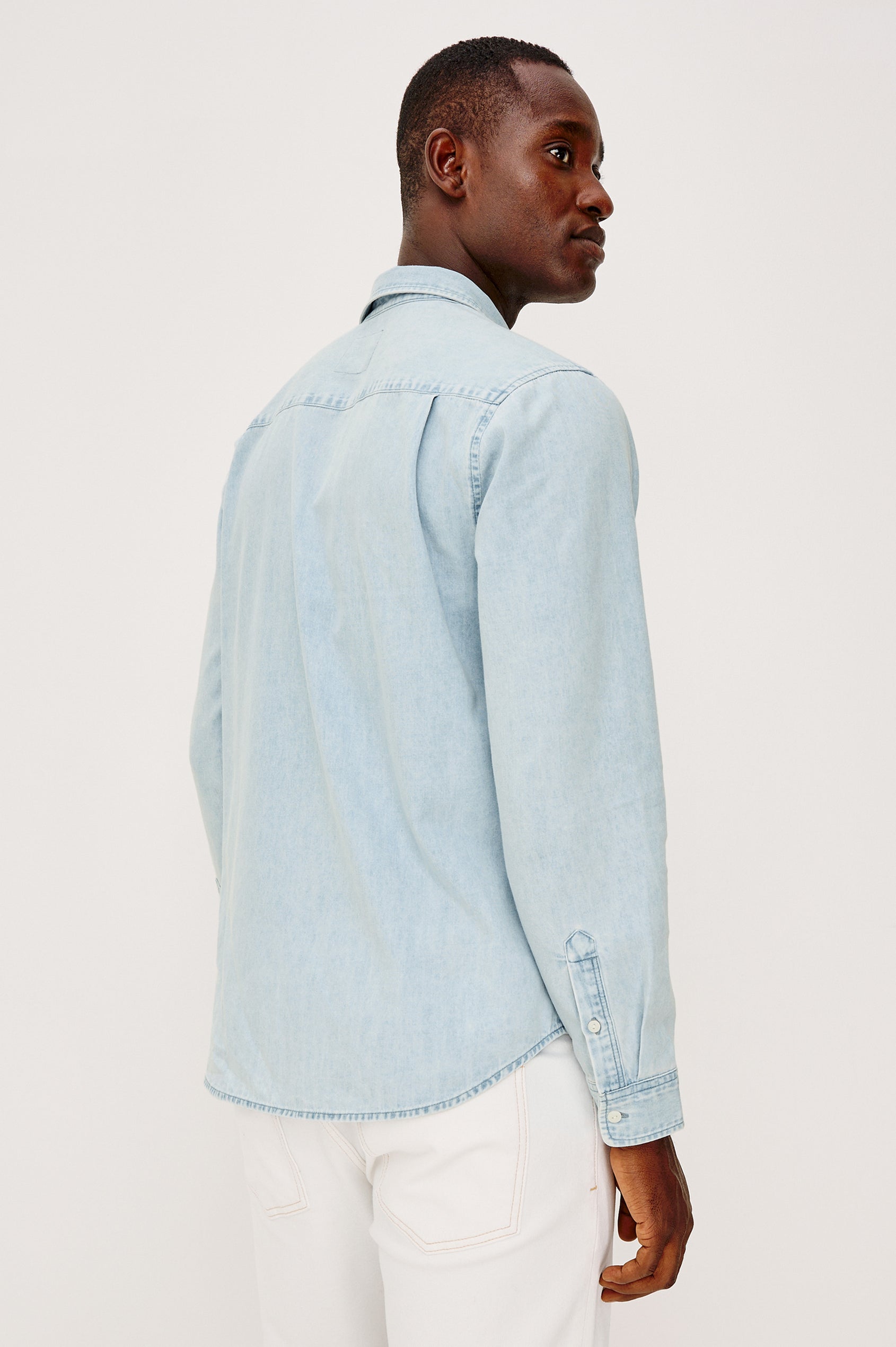 Meyer Shirt in Denim With Collar, Long Sleeves, and Chest Buttoned Flap Pockets in Light Vintage Wash - Upper Body Back View Featured on Model