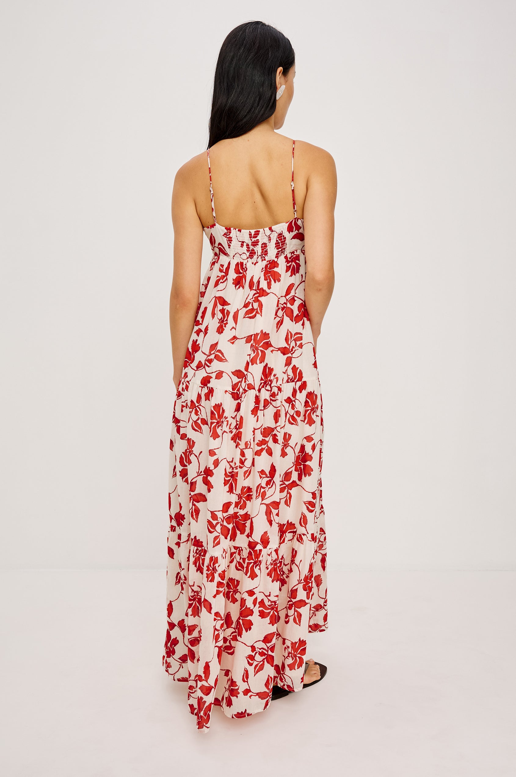 Mica Maxi Dress in Cotton With Adjustable Shoulder Straps Center-Bust Cutout With Adjustable Ties Smocked Back and Fully Lined Tiered Skirt in Red Jasmine Colorway - Full Body Back View Featured on Model