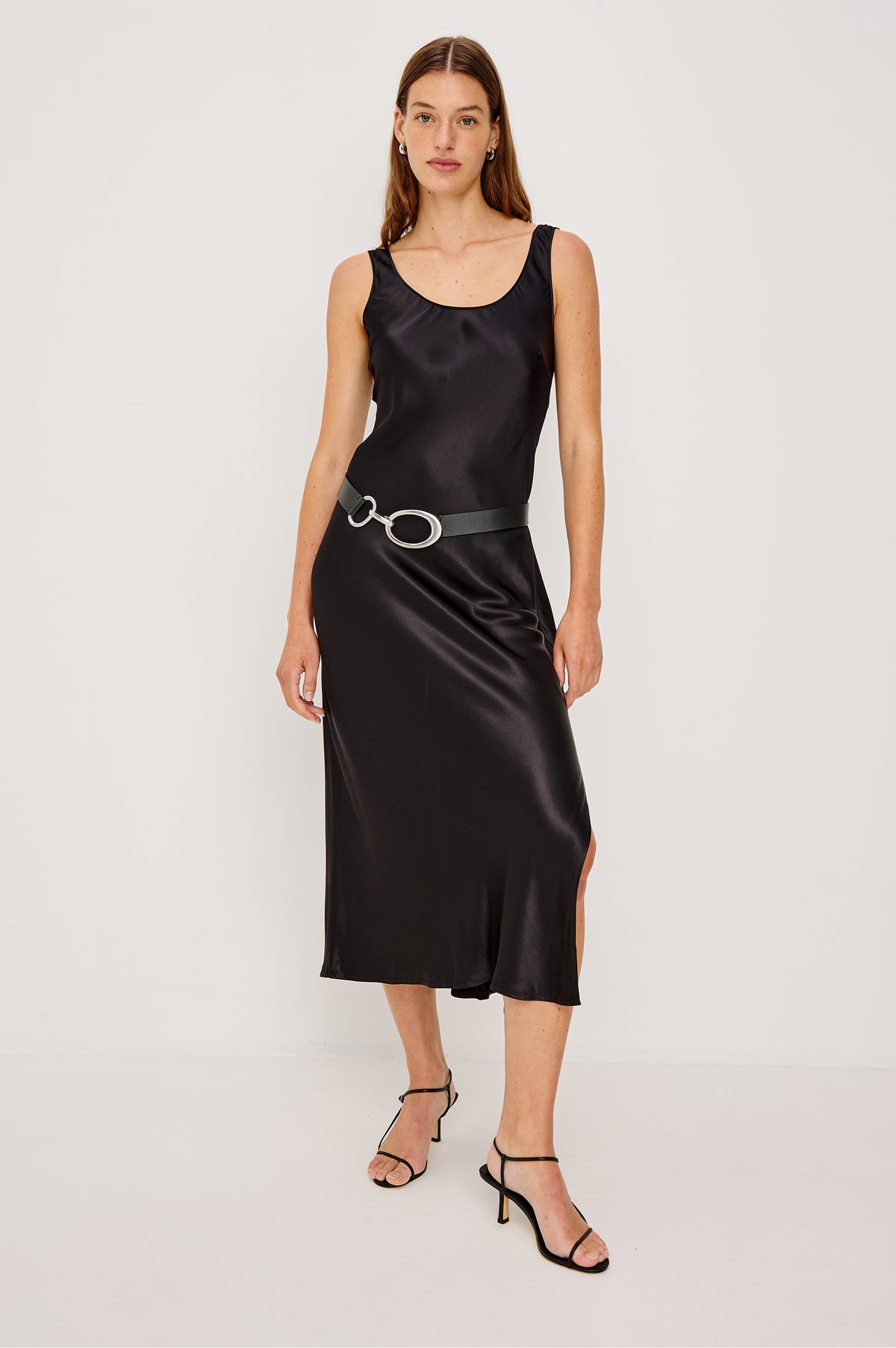 Milan belt has a silver oval-ring buckle with a clasp closure and black leather band, full body Front view featured on model.