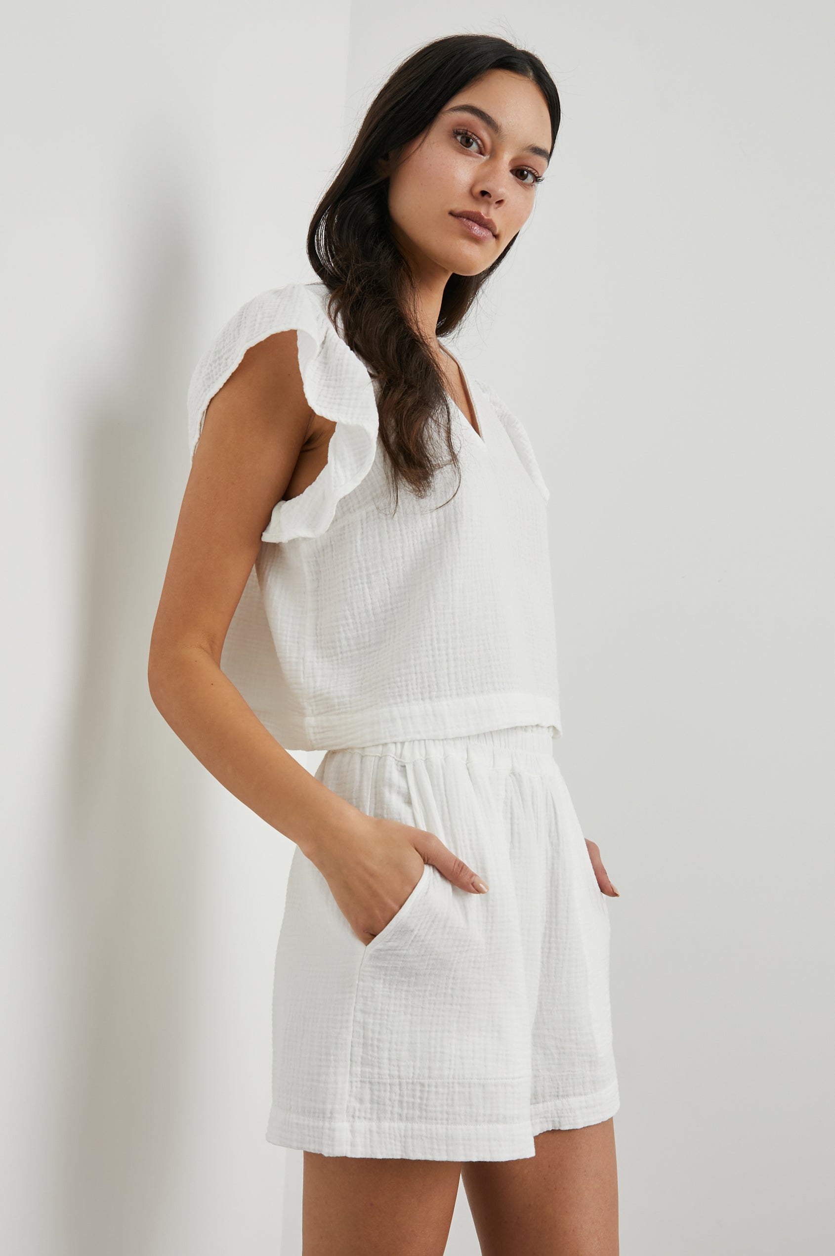 Miley Cropped, Short-Sleeve, V Neck Top with Flutter Sleeves and Textured Fabric in White Colorway - Side View Featured on Model