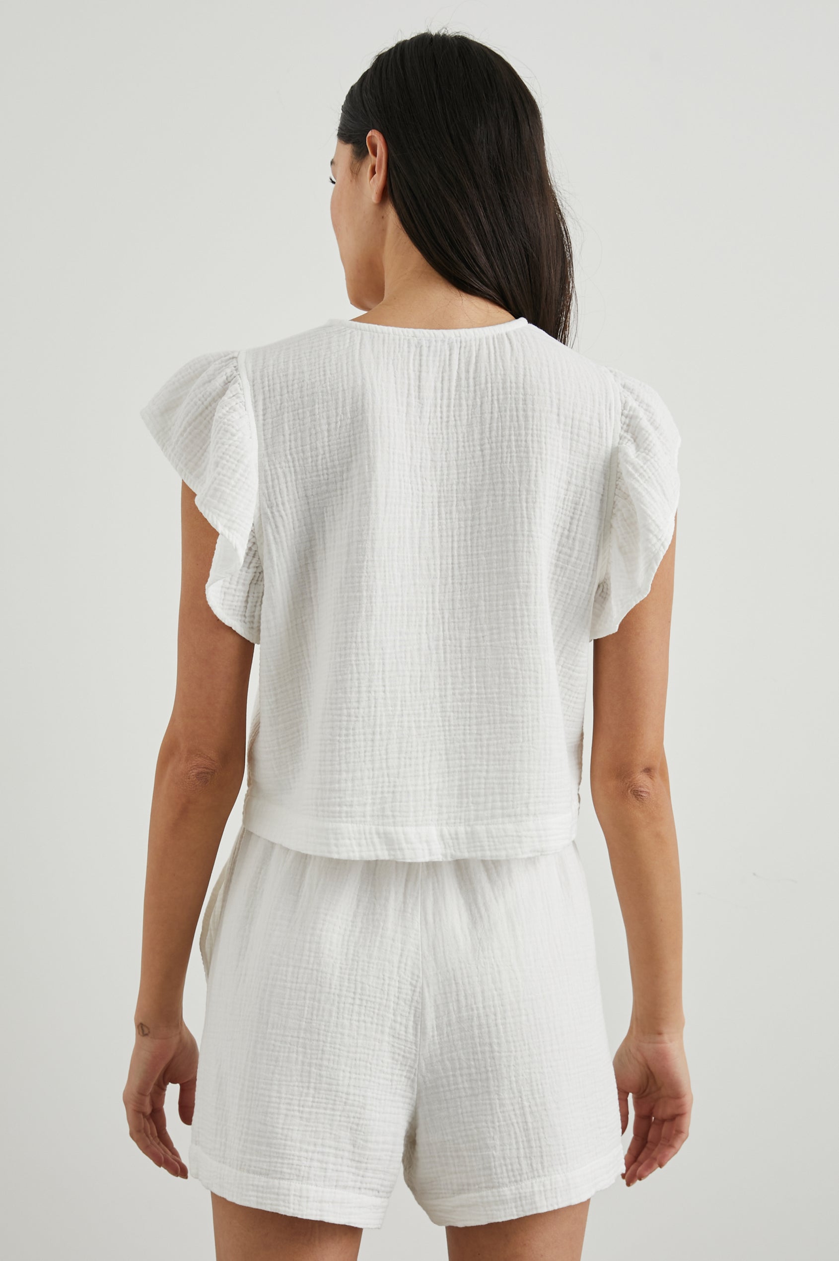 Miley Cropped, Short-Sleeve, V Neck Top with Flutter Sleeves and Textured Fabric in White Colorway - Back View Featured on Model