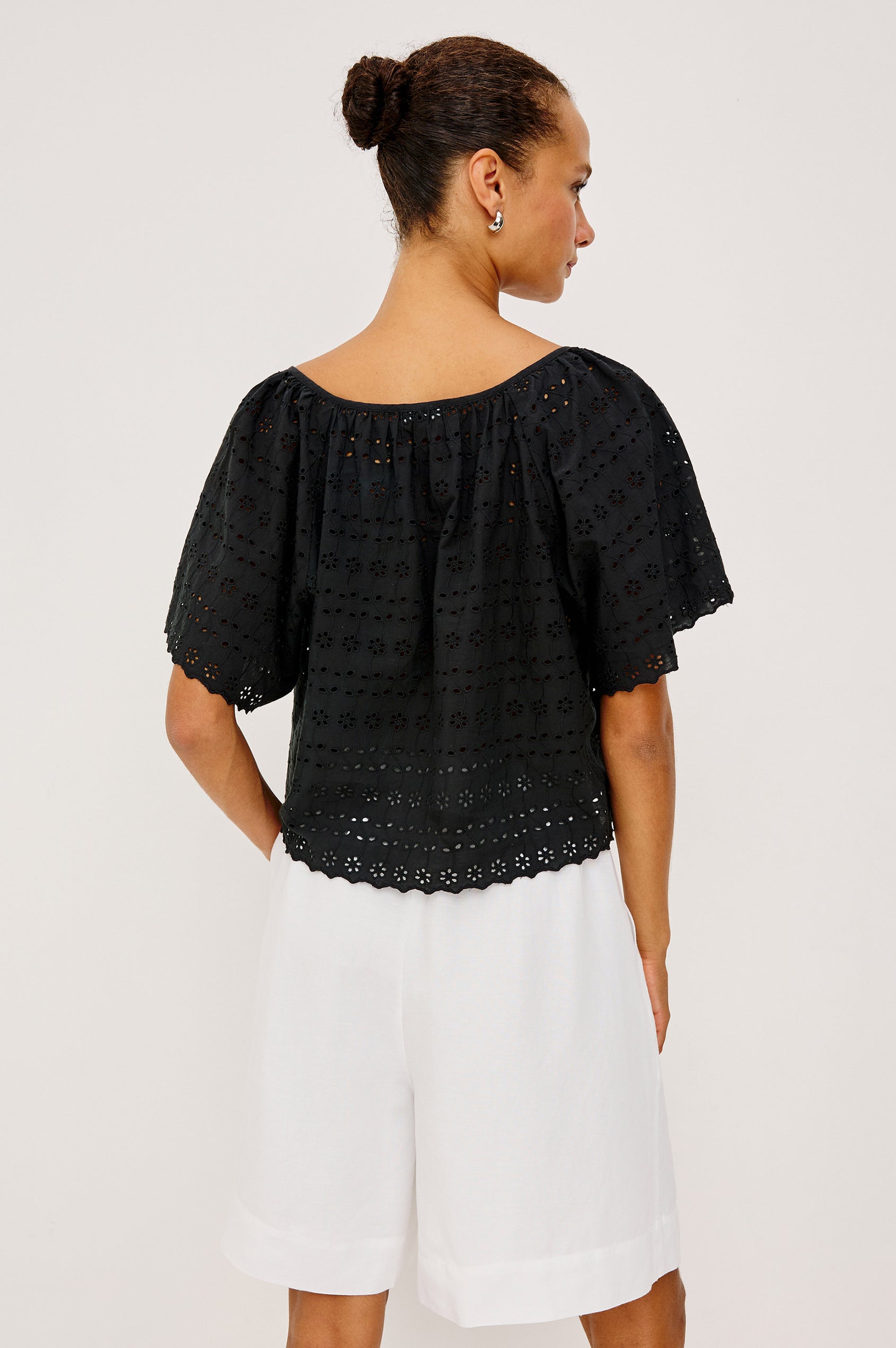 Miller Top in Cotton Voile With Cropped Fit, Wide Short Sleeves, Scoop Neck, Front Buttons, and No Lining in Black Eyelet Colorway - Upper Body Front View Featured on Model