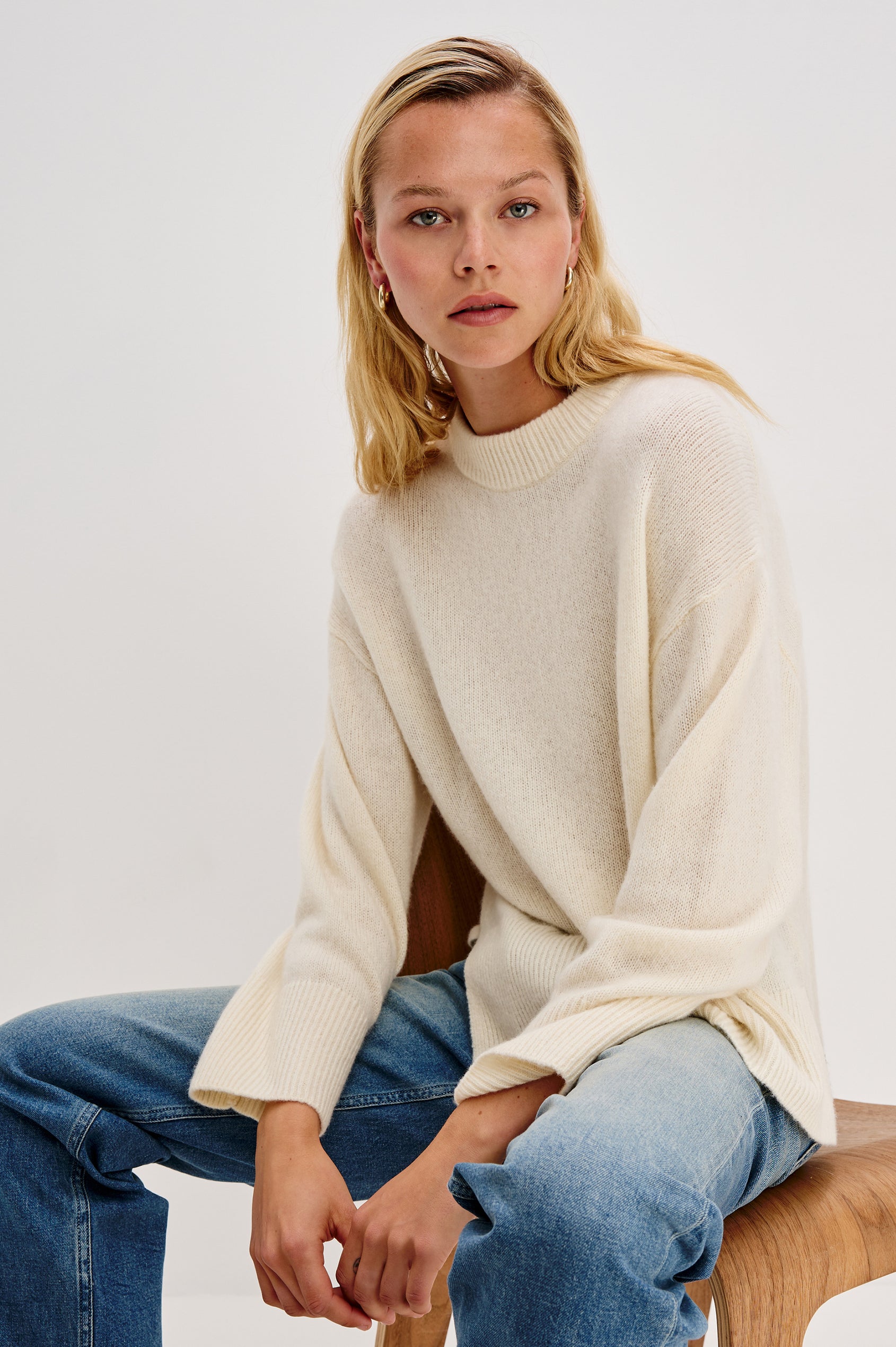 Miranda Long-Sleeve Sweater with a Mock Neck, Side Slits, and Ribbed Trim in Ivory Colorway - Front View Featured on Model