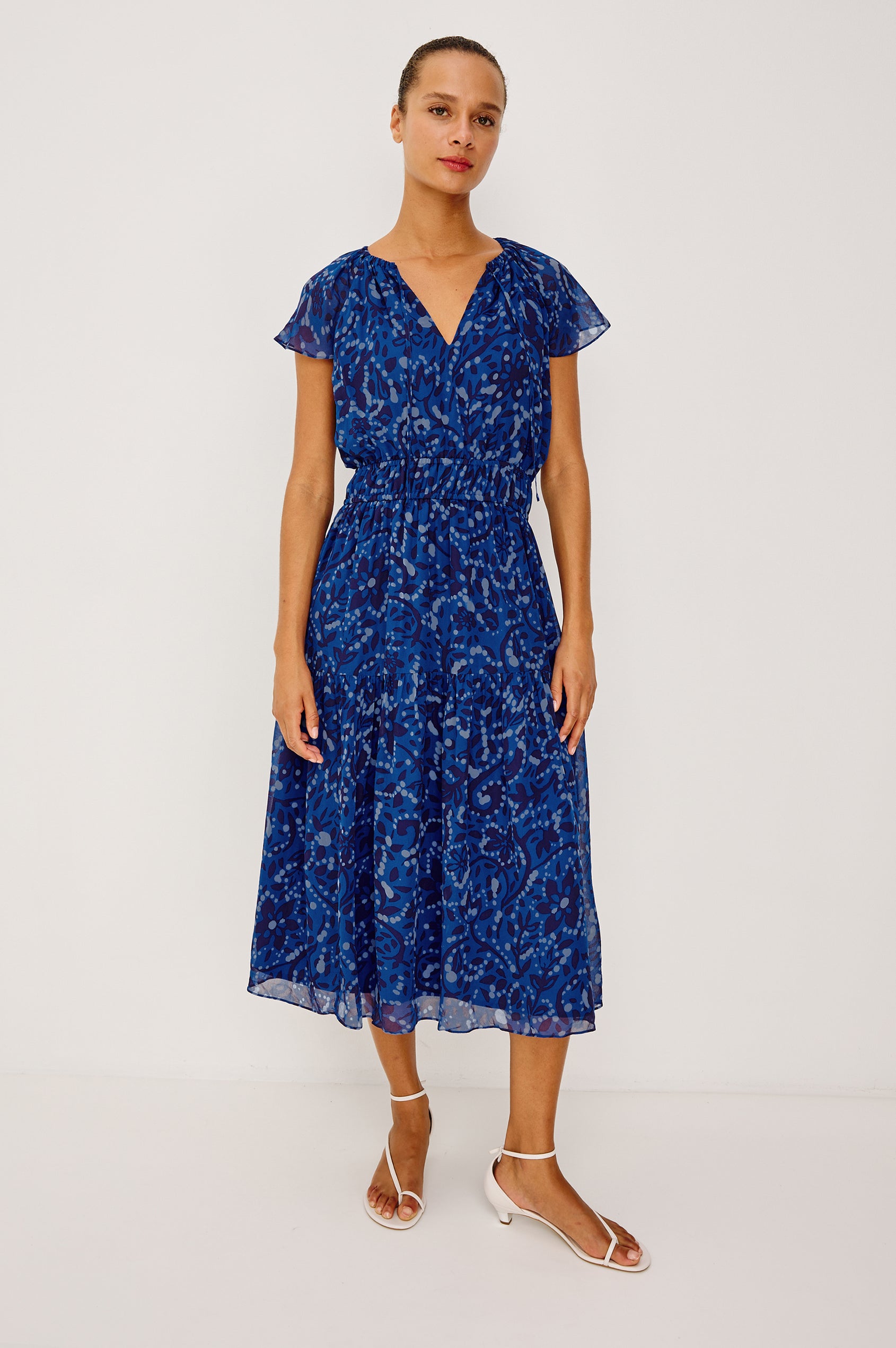 Mirielle Maxi Dress in Chiffon With V-Neckline, Elastic Waist, Center Front Ties, Raglan Short Sleeves, Single Tier Skirt and is Fully Lined - Full Body Front View Featured on Model