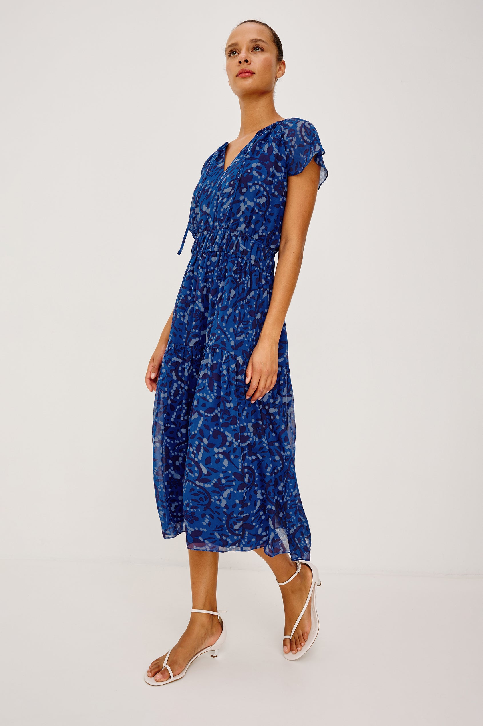 Mirielle Maxi Dress in Chiffon With V-Neckline, Elastic Waist, Center Front Ties, Raglan Short Sleeves, Single Tier Skirt and is Fully Lined - Full Body Front View Featured on Model