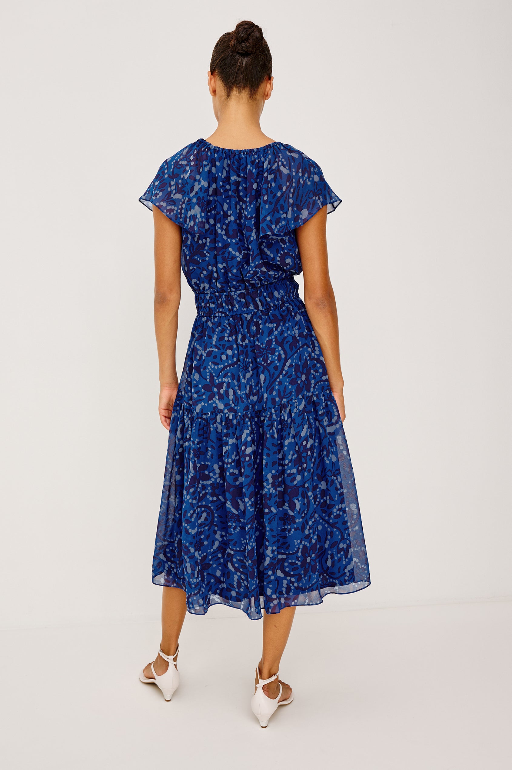 Mirielle Maxi Dress in Chiffon With V-Neckline, Elastic Waist, Center Front Ties, Raglan Short Sleeves, Single Tier Skirt and is Fully Lined - Full Body Back View Featured on Model