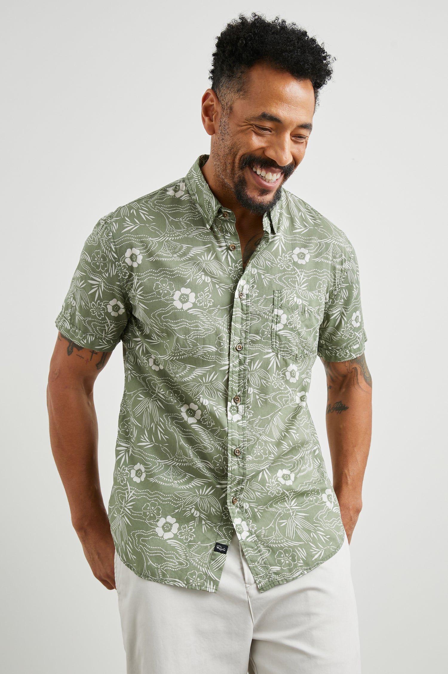 Monaco Short-Sleeve Button Up with a Chest Patch Pocket in Japanese Stencil Fatigue Colorway, a White Floral Print on Fatigue - Front View Featured on Model