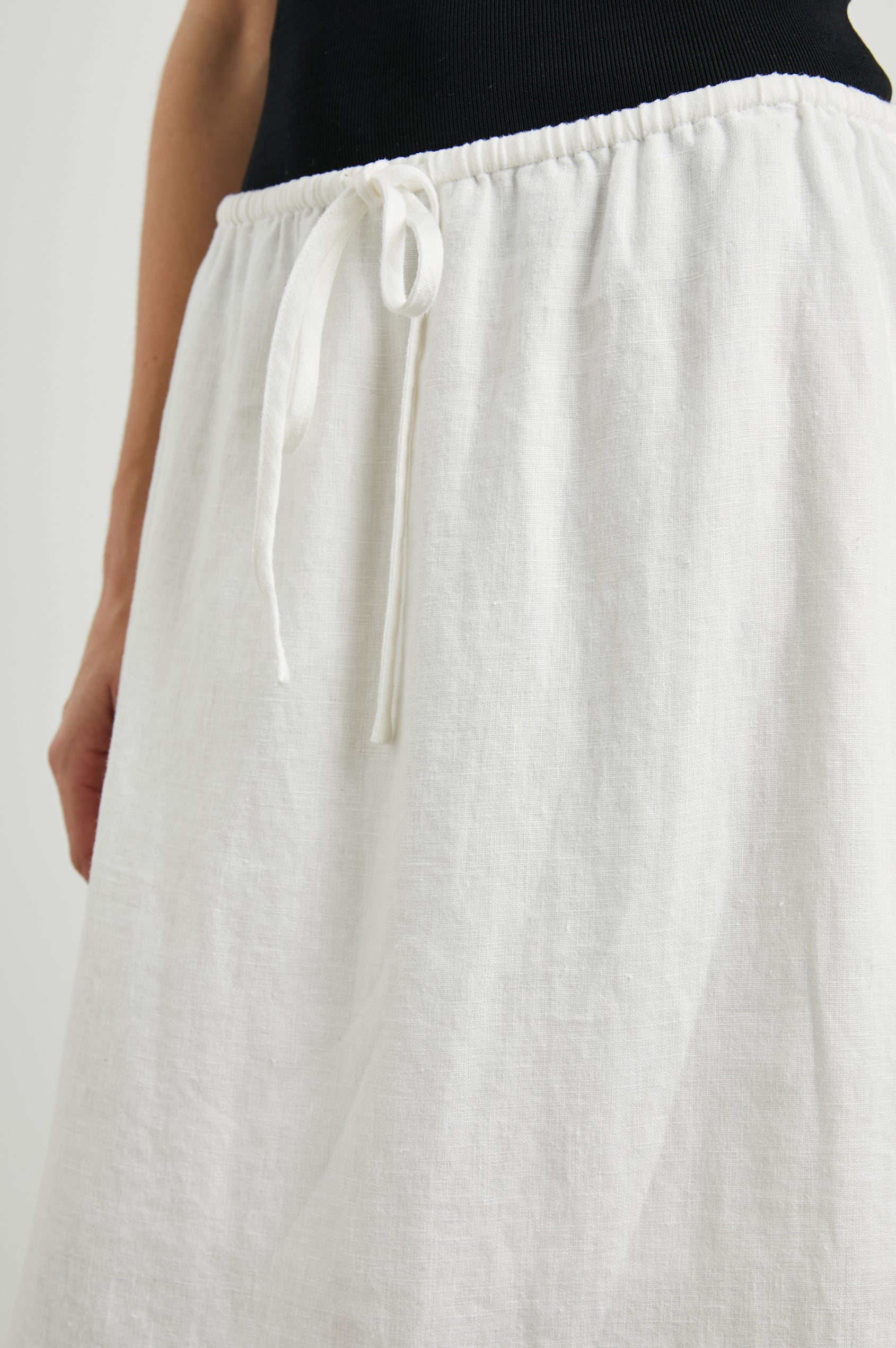 Monet Midi Skirt with Two Side Slits and a Drawstring Waist in White Colorway - Front View Featured on Model 