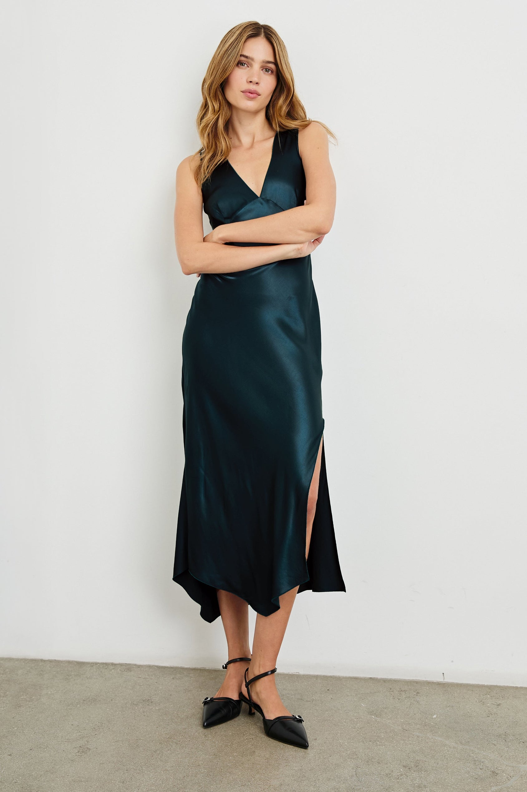 Monique Sleeveless Midi Dress with an Asymmetrical Hem Line, Side Slit, Deep V Neck, and Wide Shoulder Straps in Deep Sea Colorway - Front Full Body View Featured on Model