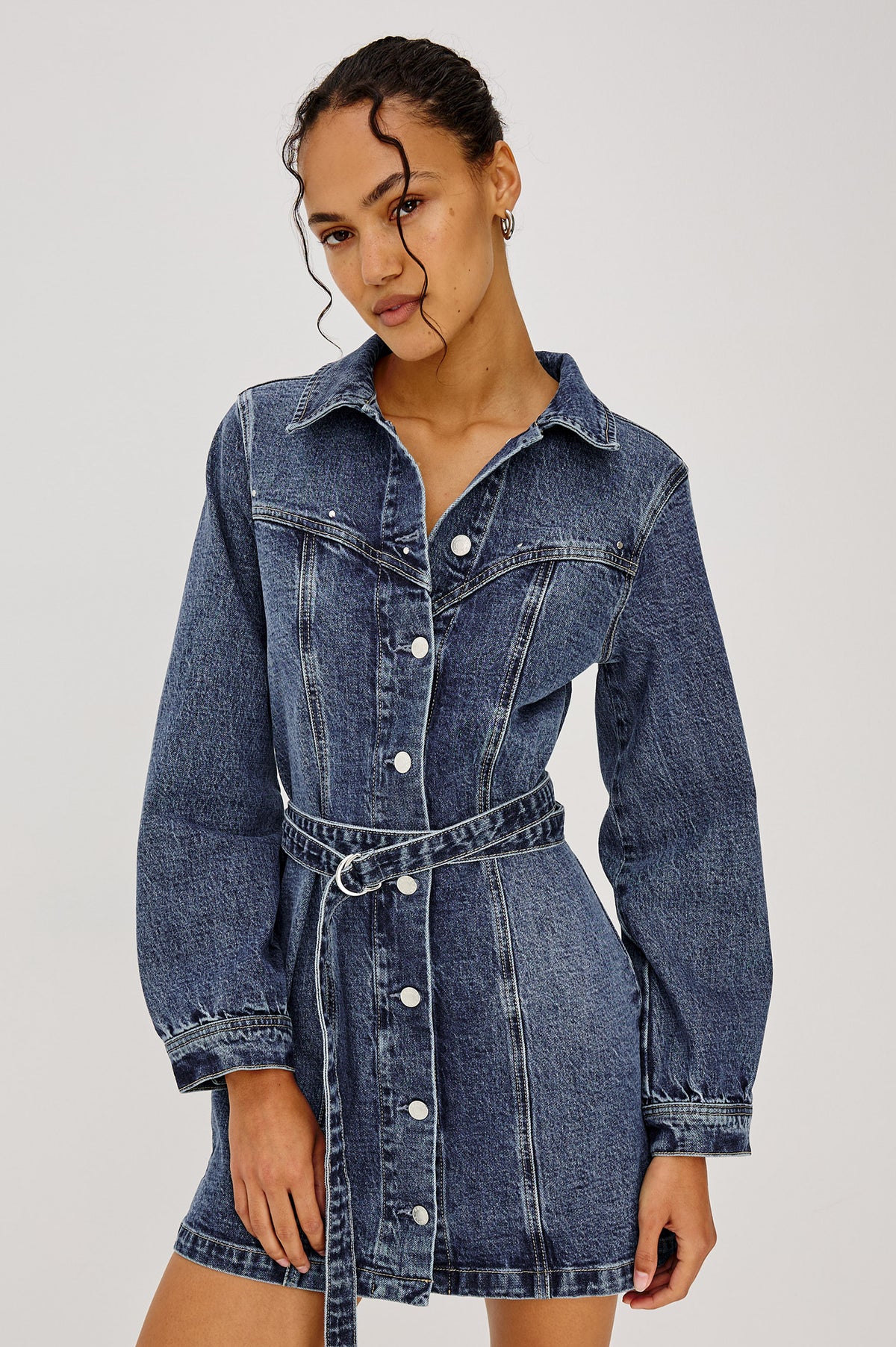 Montant Mini Dress in Comfort-Stretch Denim With Studded Front Yoke, Button-Front, Long Sleeves, and Double Belt in Blue Bonnet Colorway - Upper Body Front View Featured on Model