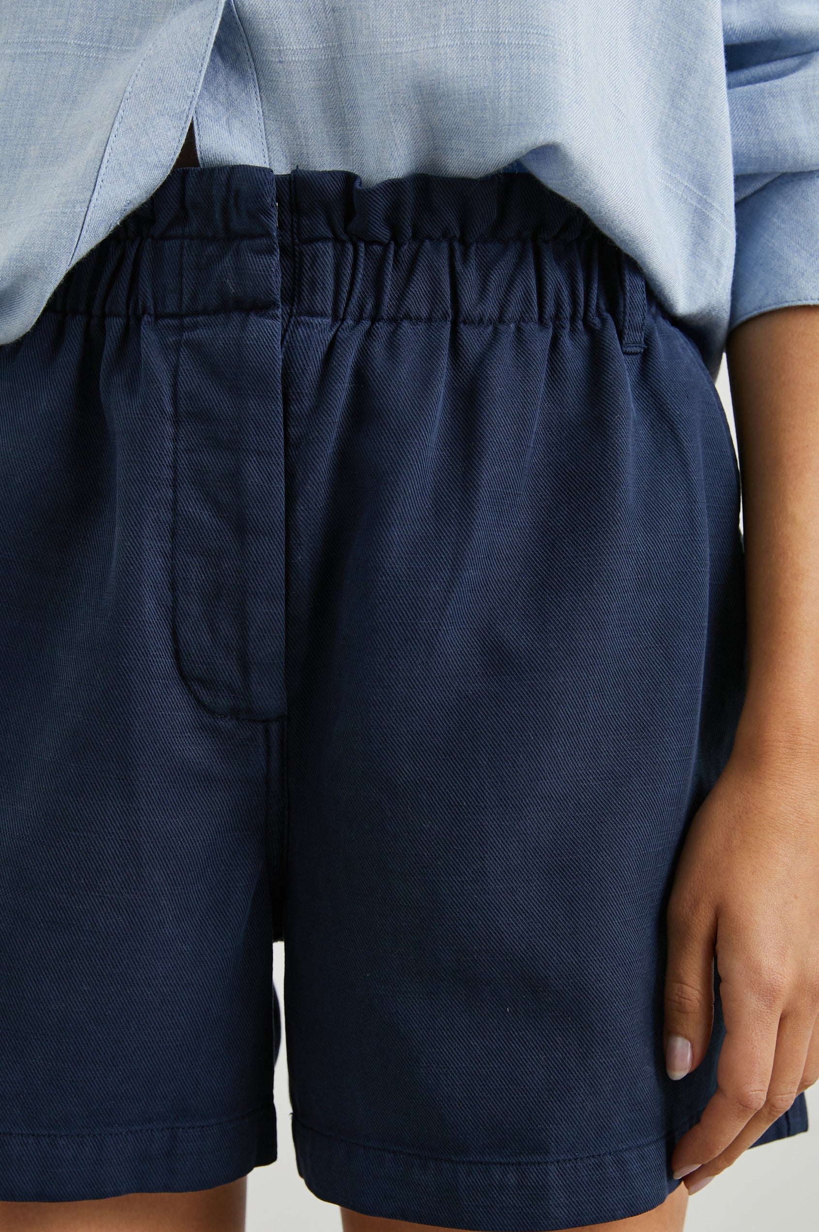 Monte Shorts with a Cinched Waist, Belt Loops, Two Front Pockets, and Two Back Patch Pockets in Navy Colorway - Front View Featured on Model