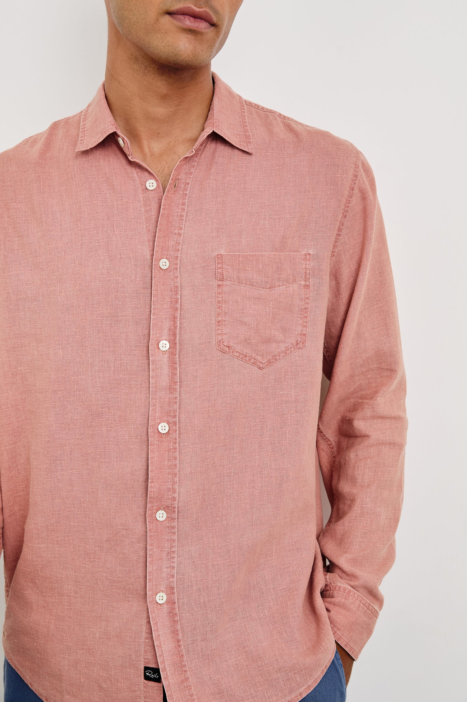 Mykonos linen button up long sleeve with front chest pocket and collar in Desert Rose - close up of details on model
