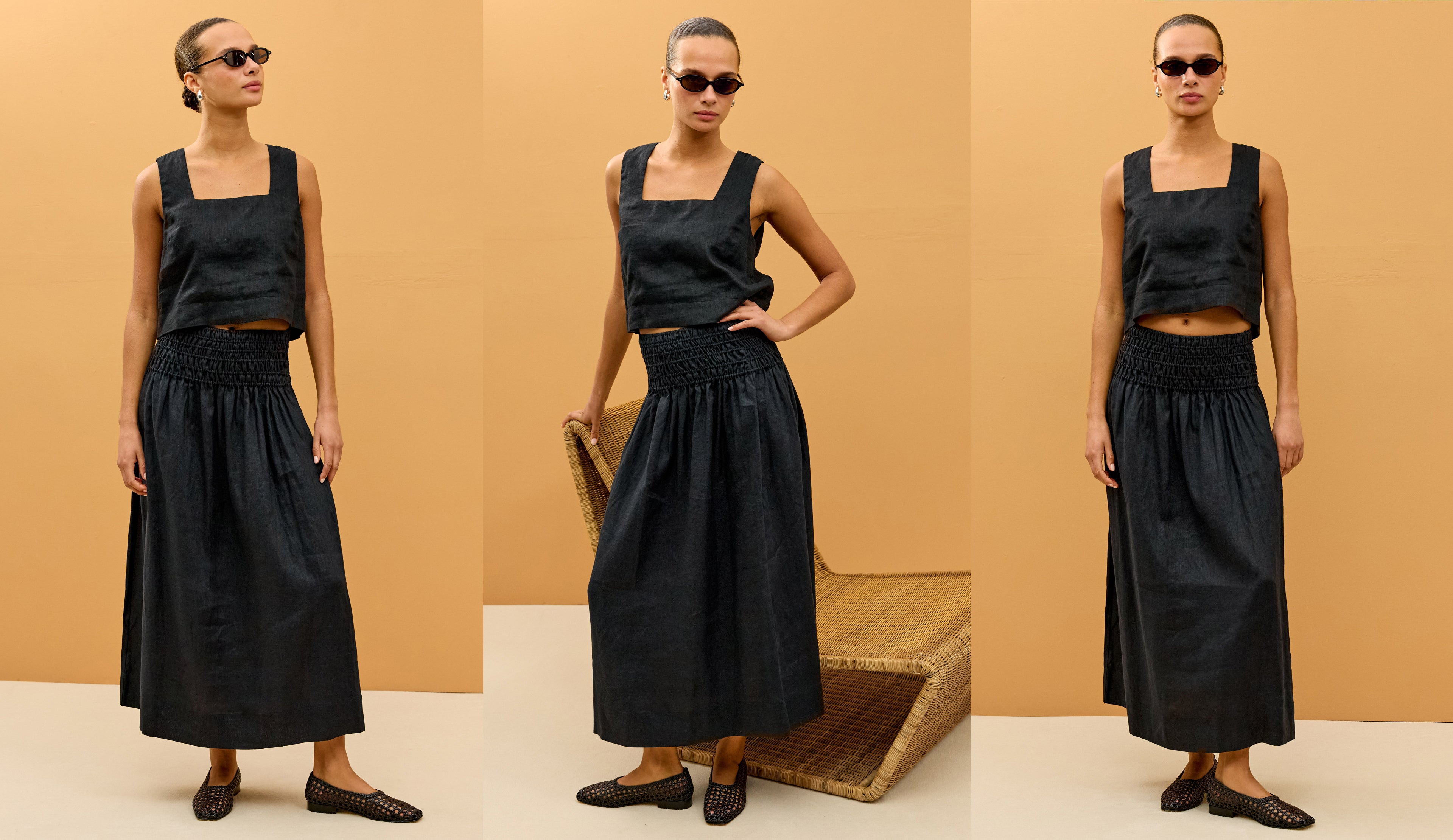 Woman wearing a black sleeveless top and skirt set against a beige background