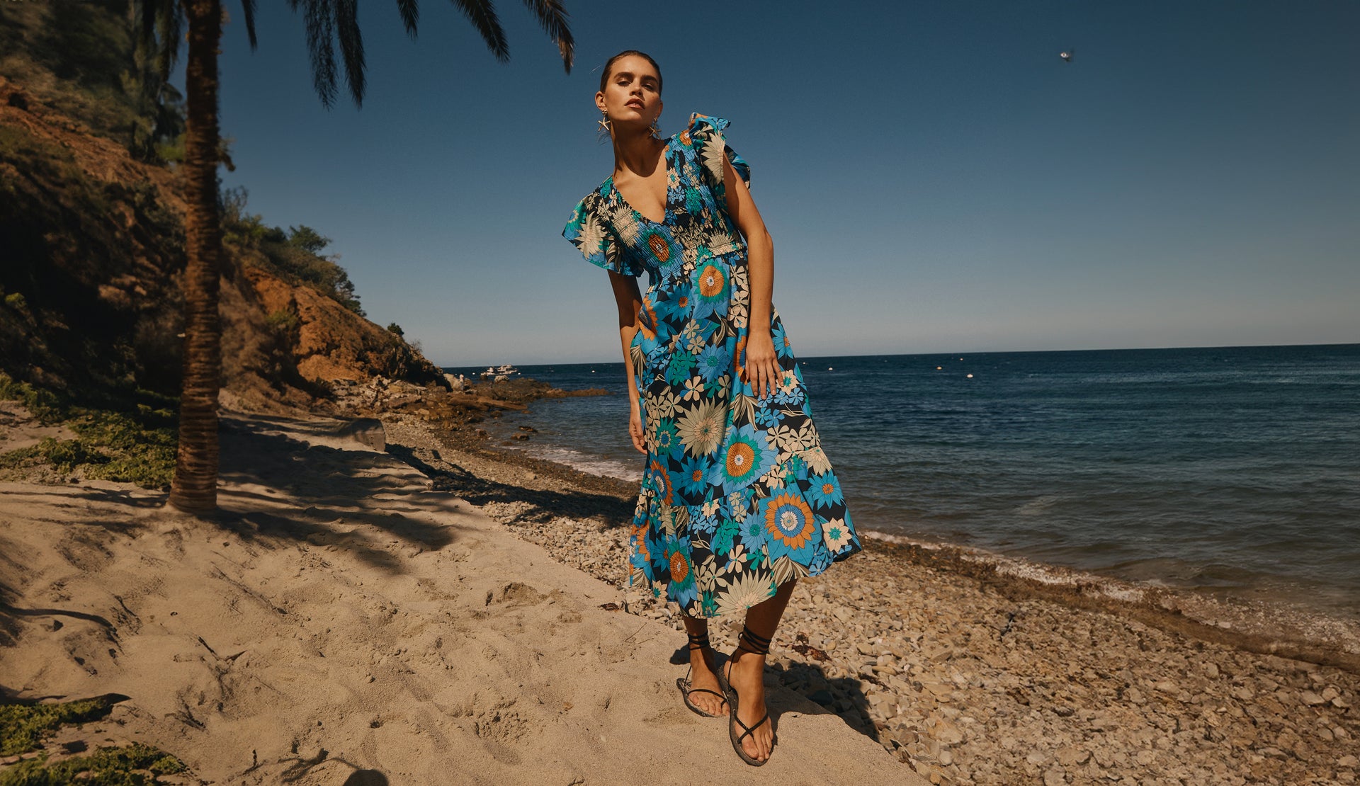 FRONT FULL BODY EDITORIAL IMAGE OF MODEL ON THE BEACH WEARING CLEMENTINE DRESS