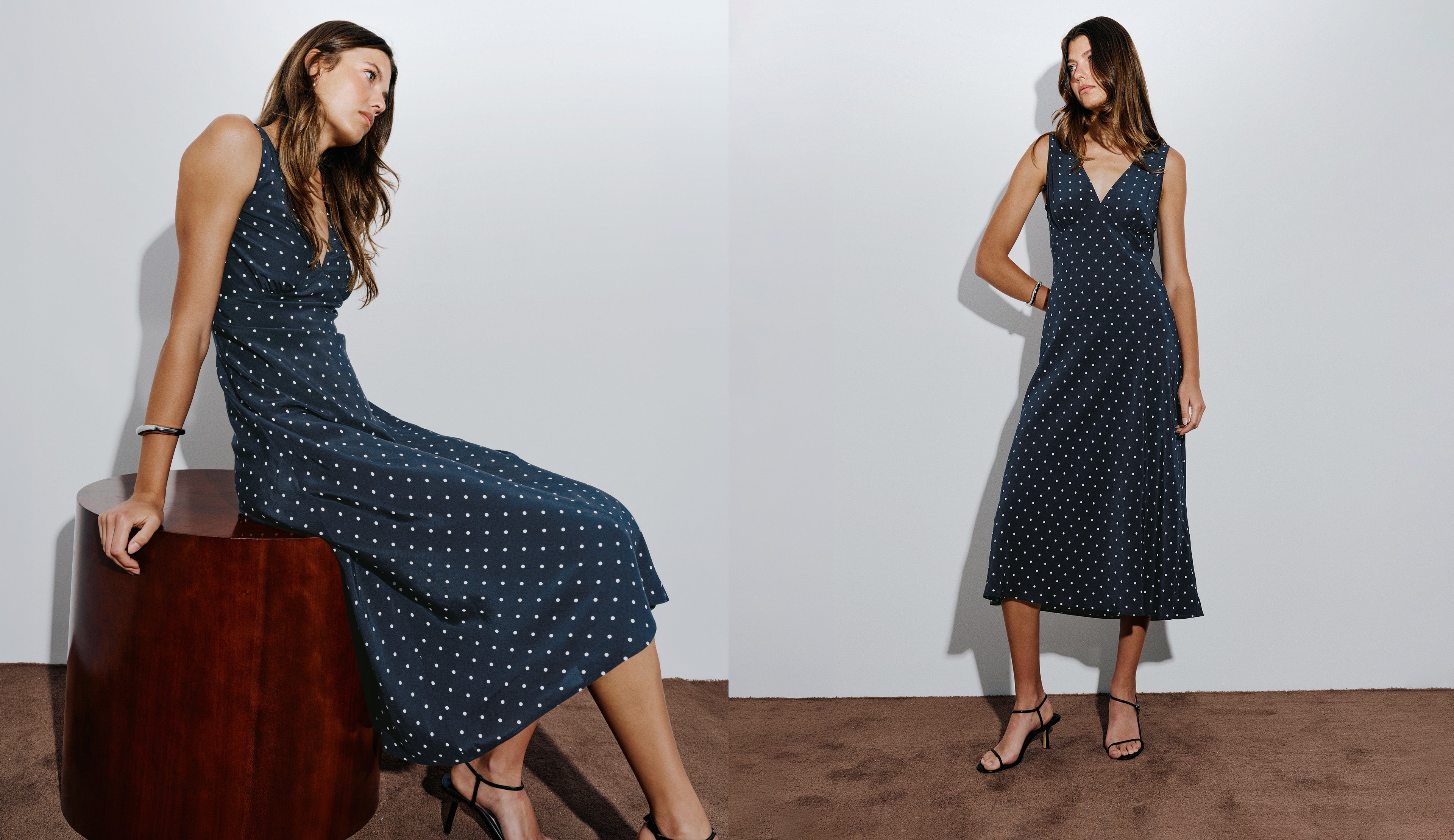 Woman wearing a blue midi polka dot dress with black heels.