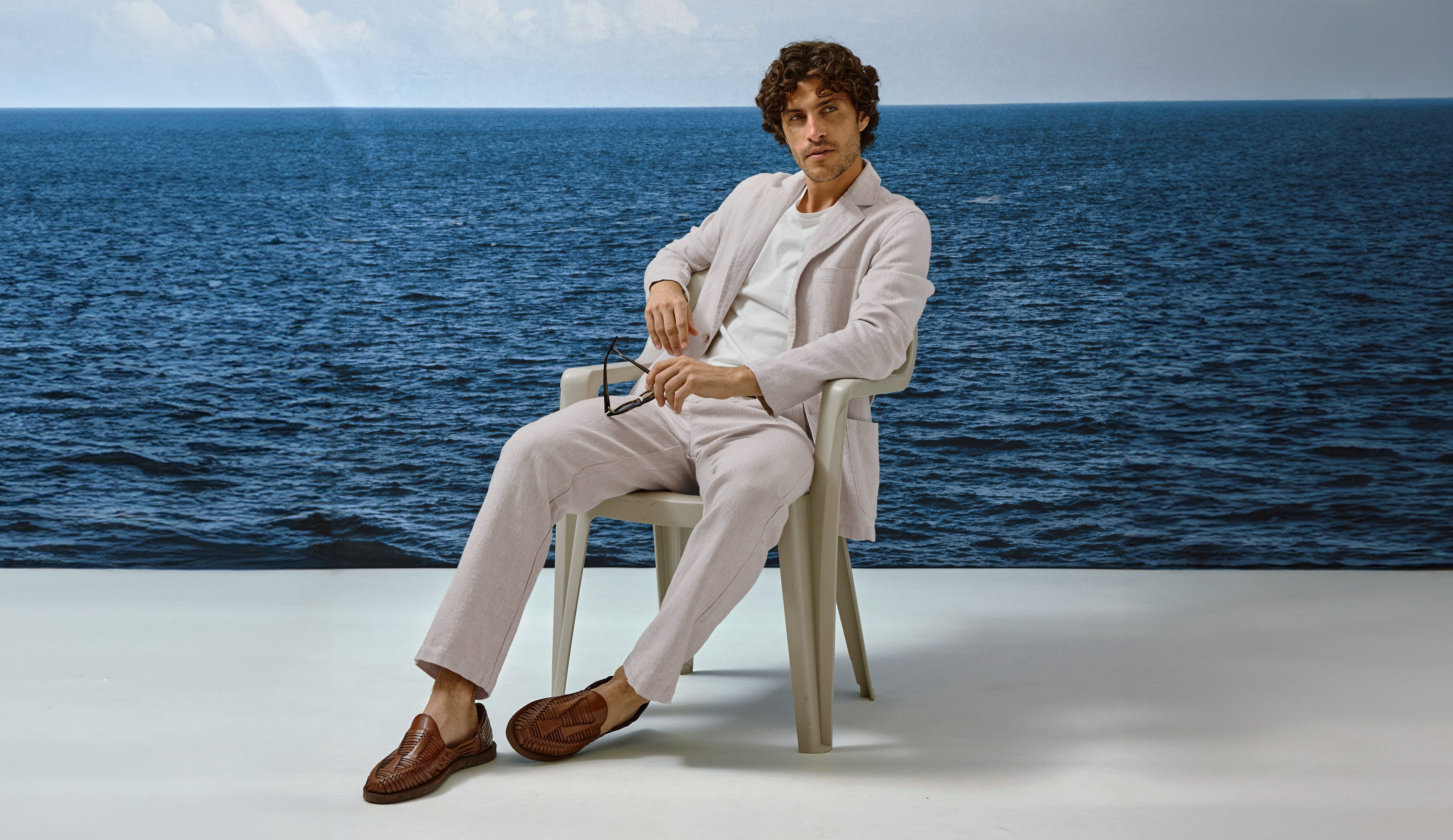 Man sitting on a chair by the ocean