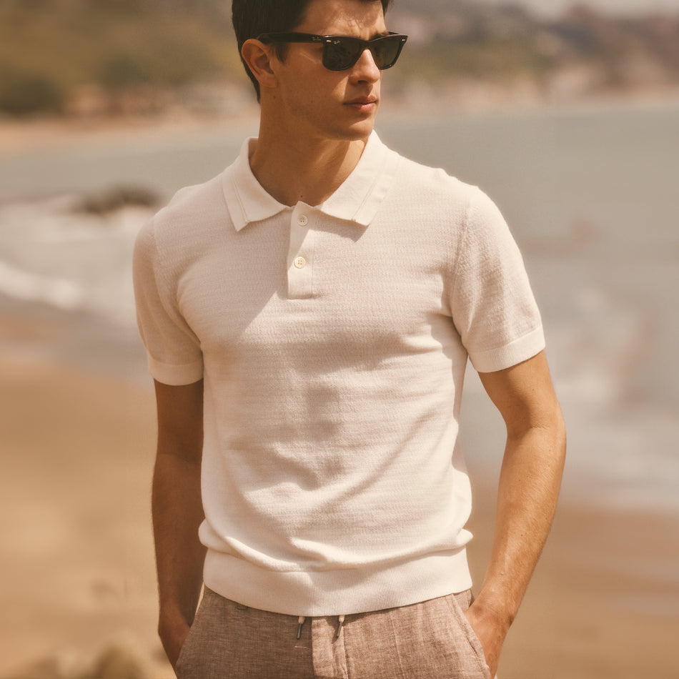 EDITORIAL IMAGE OF MODEL ON THE BEACH WEARING SHOREDITCH POLO SHIRT