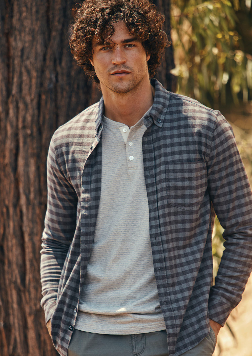 FRONT EDITORIAL IMAGE OF MODEL WEARING REID SHIRT AND SKHI HENLEY