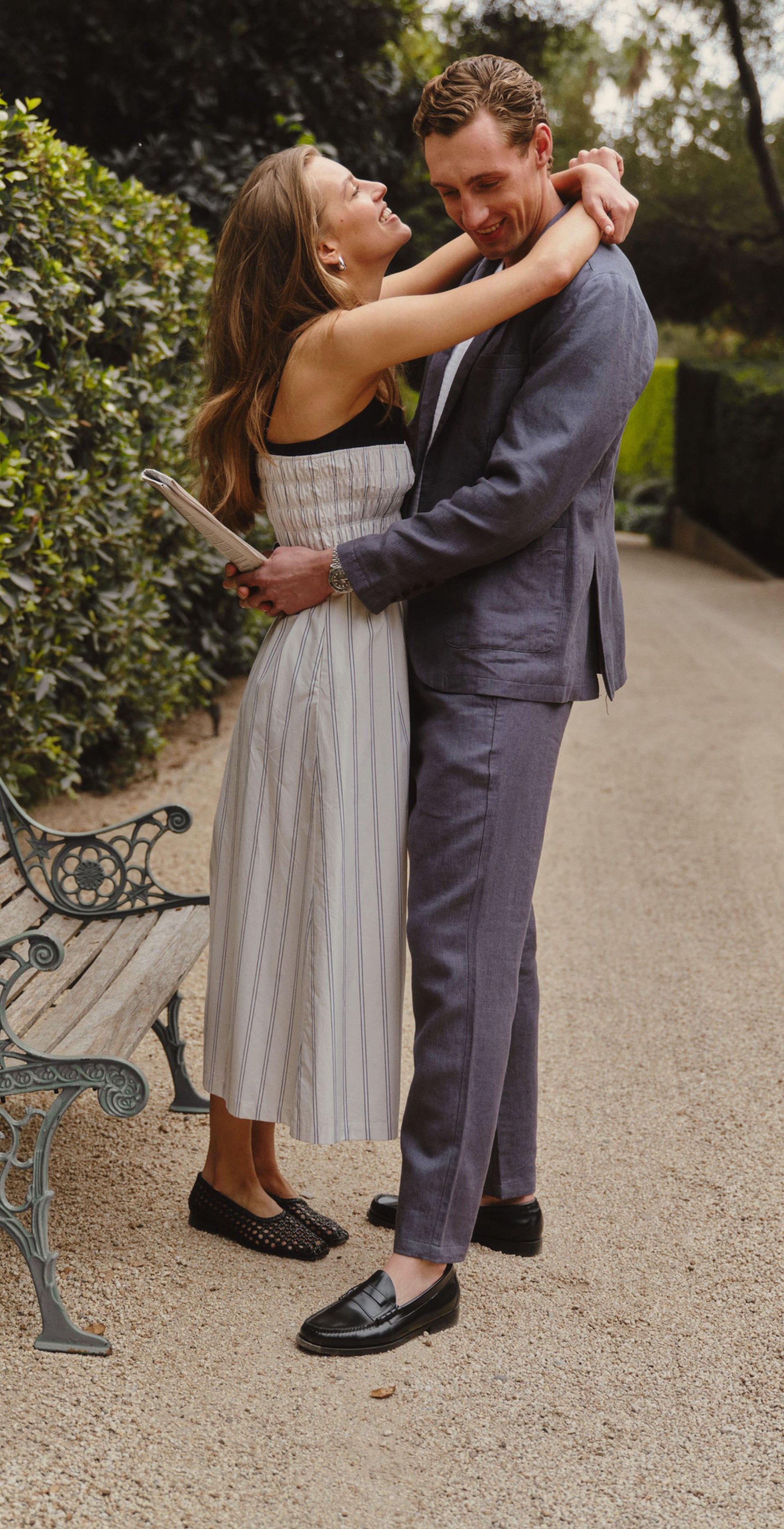 A three-panel lifestyle collage showing a couple outdoors in a garden path. The woman wears a sleeveless white dress with thin vertical pinstripes and a black band at the neckline.