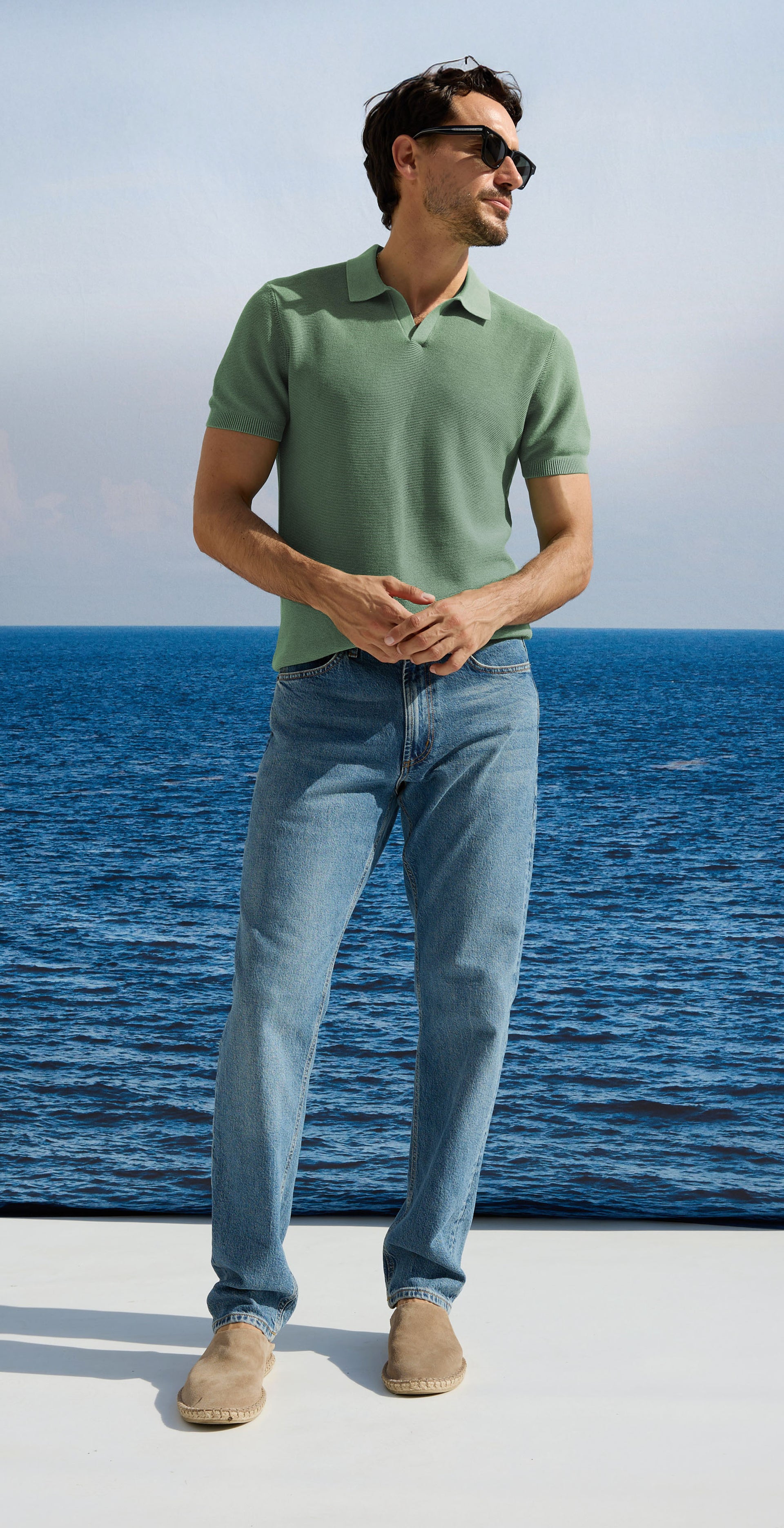 Man in a green shirt with blue jeans