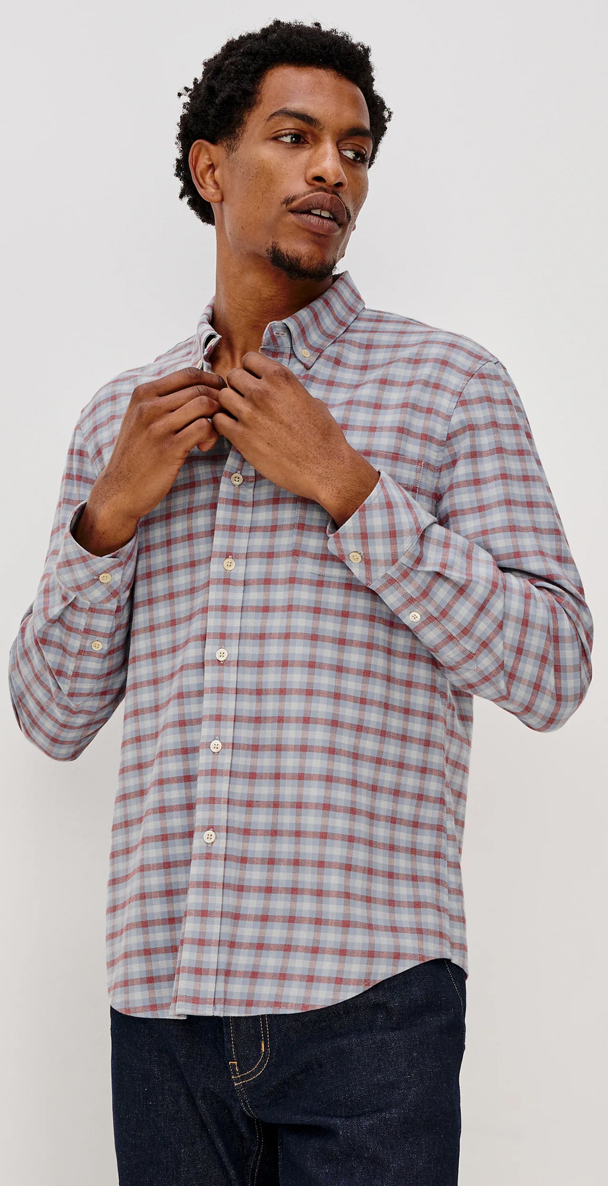 Man wearing a plaid shirt in three different poses against a white background