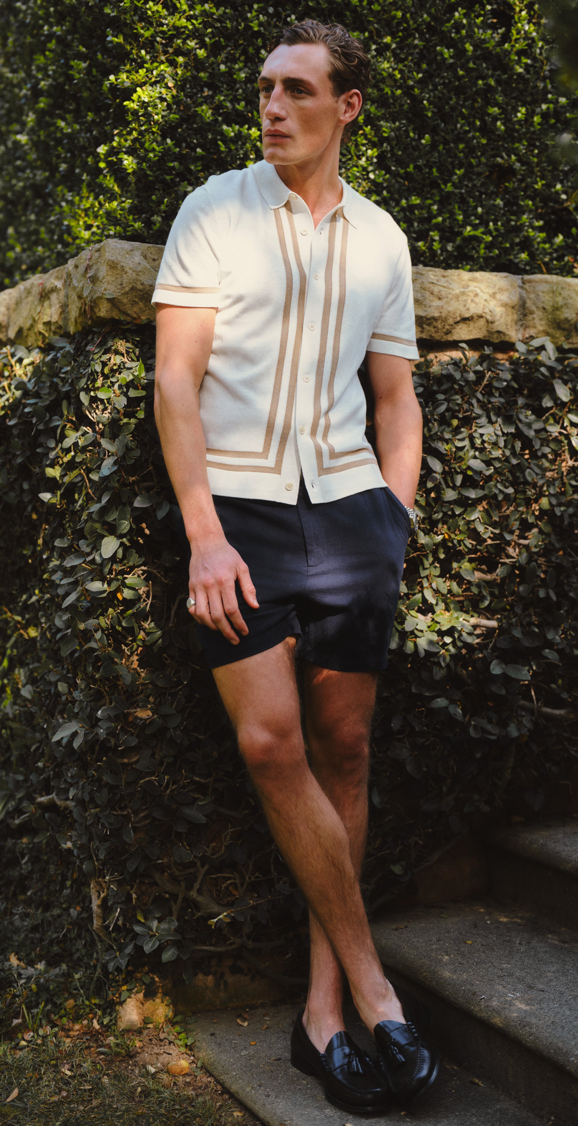 Man wearing a white shirt with brown accents in various outdoor settings.