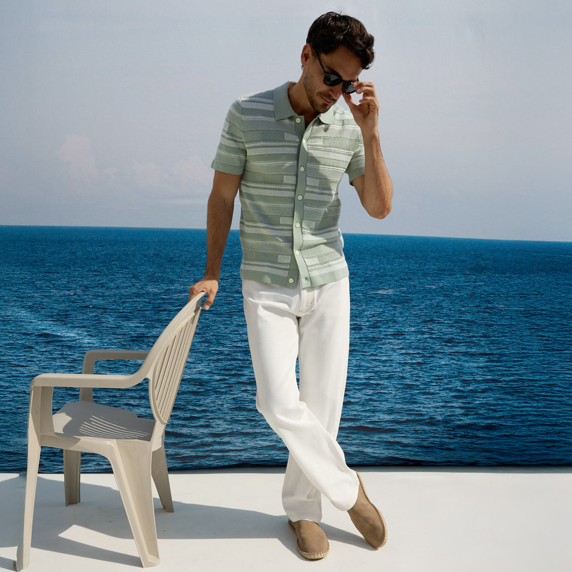 Man wearing green button down shirt with white pants dressed for summer