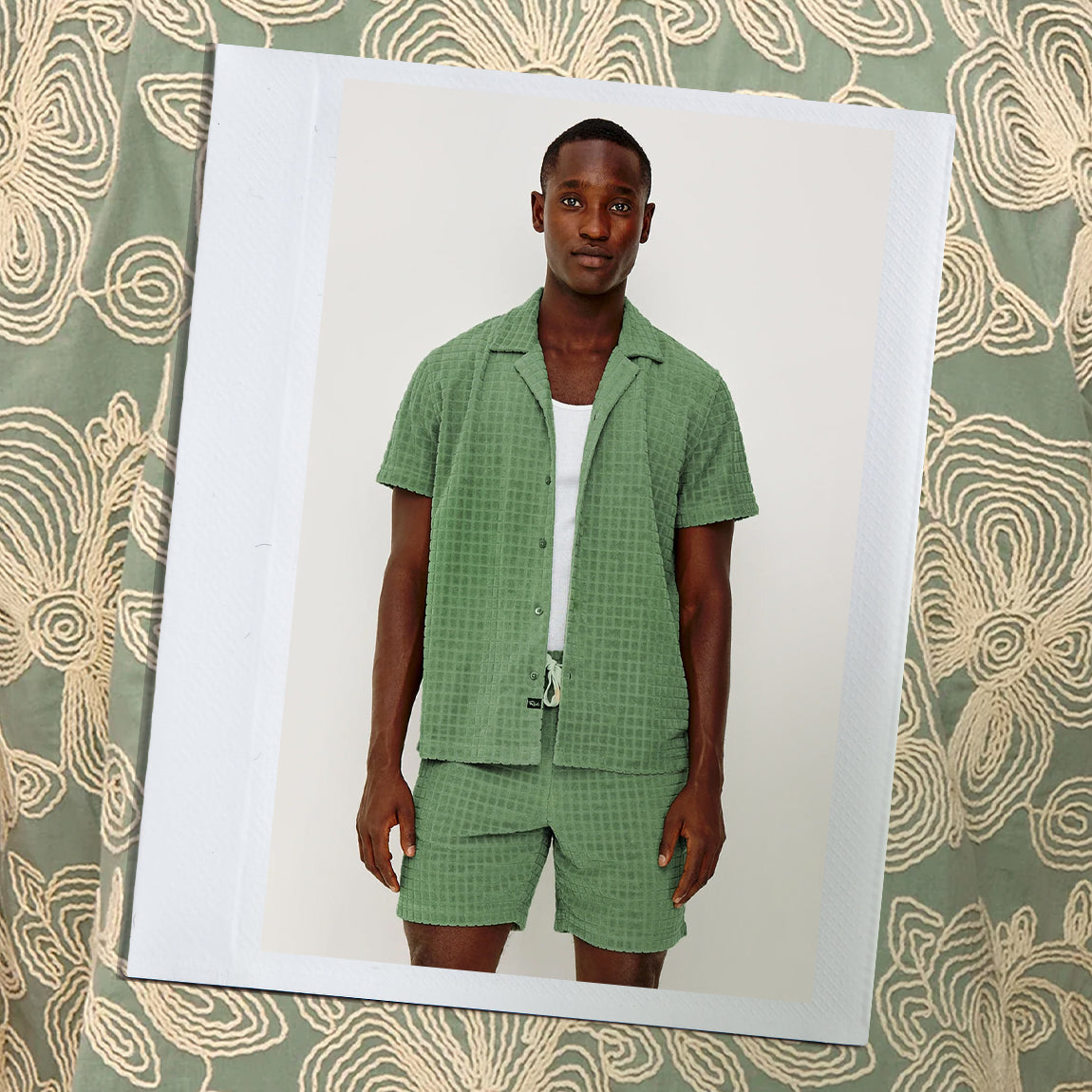 Man wearing a green checkered outfit on a patterned background