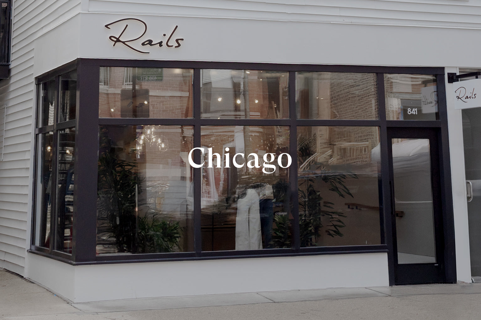 OUTSIDE OF FRONT OF RAILS CHICAGO RETAIL STORE SHOWING LARGE FRONT WINDOW