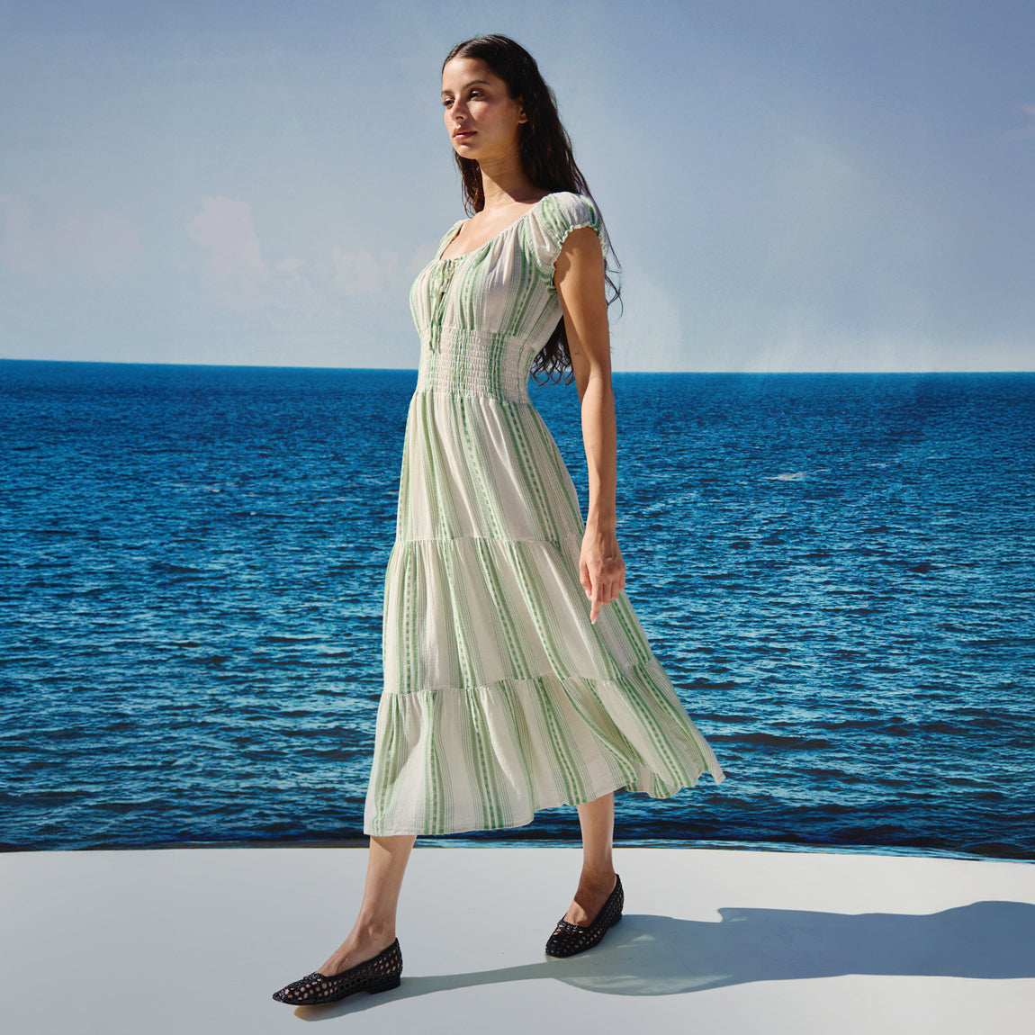Woman in a green and white striped dress