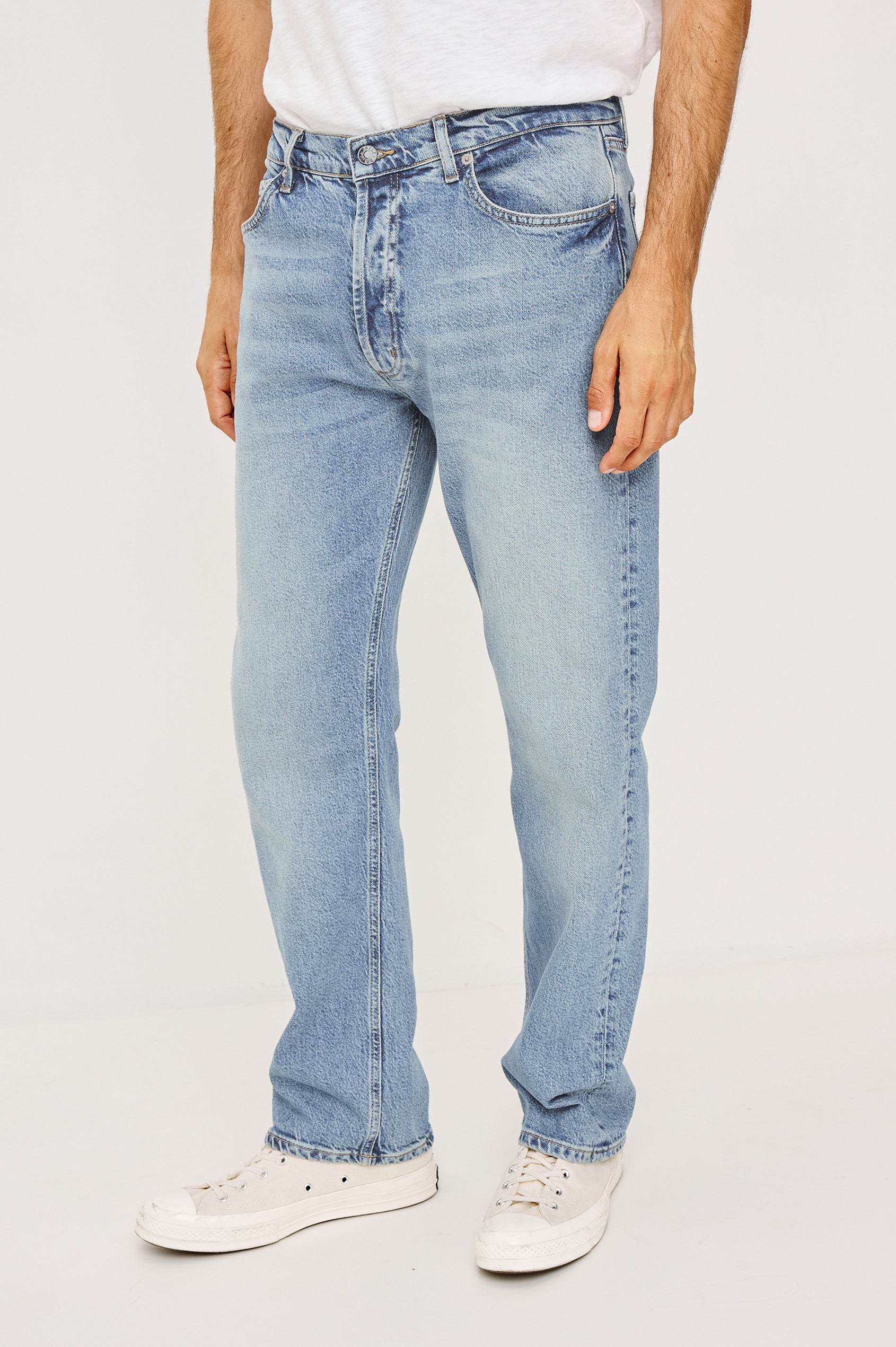 Nash is a straight leg 5-Pocket denim jean a zip fly and button closure as well as rivets in a Ranchwater Wash. Front view featured on model.