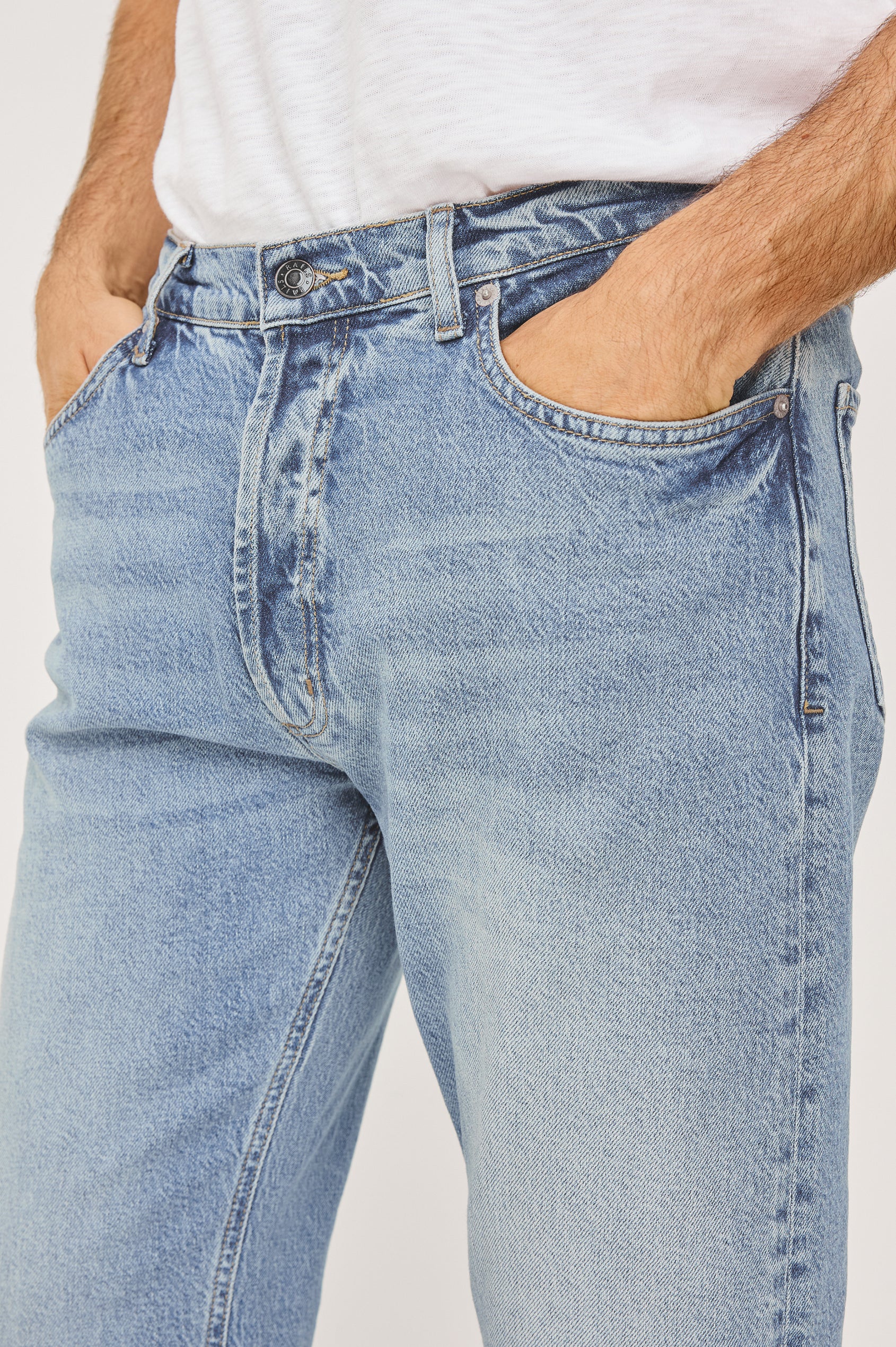 Nash is a straight leg 5-Pocket denim jean a zip fly and button closure as well as rivets in a Ranchwater Wash. Close up front view featured on model.