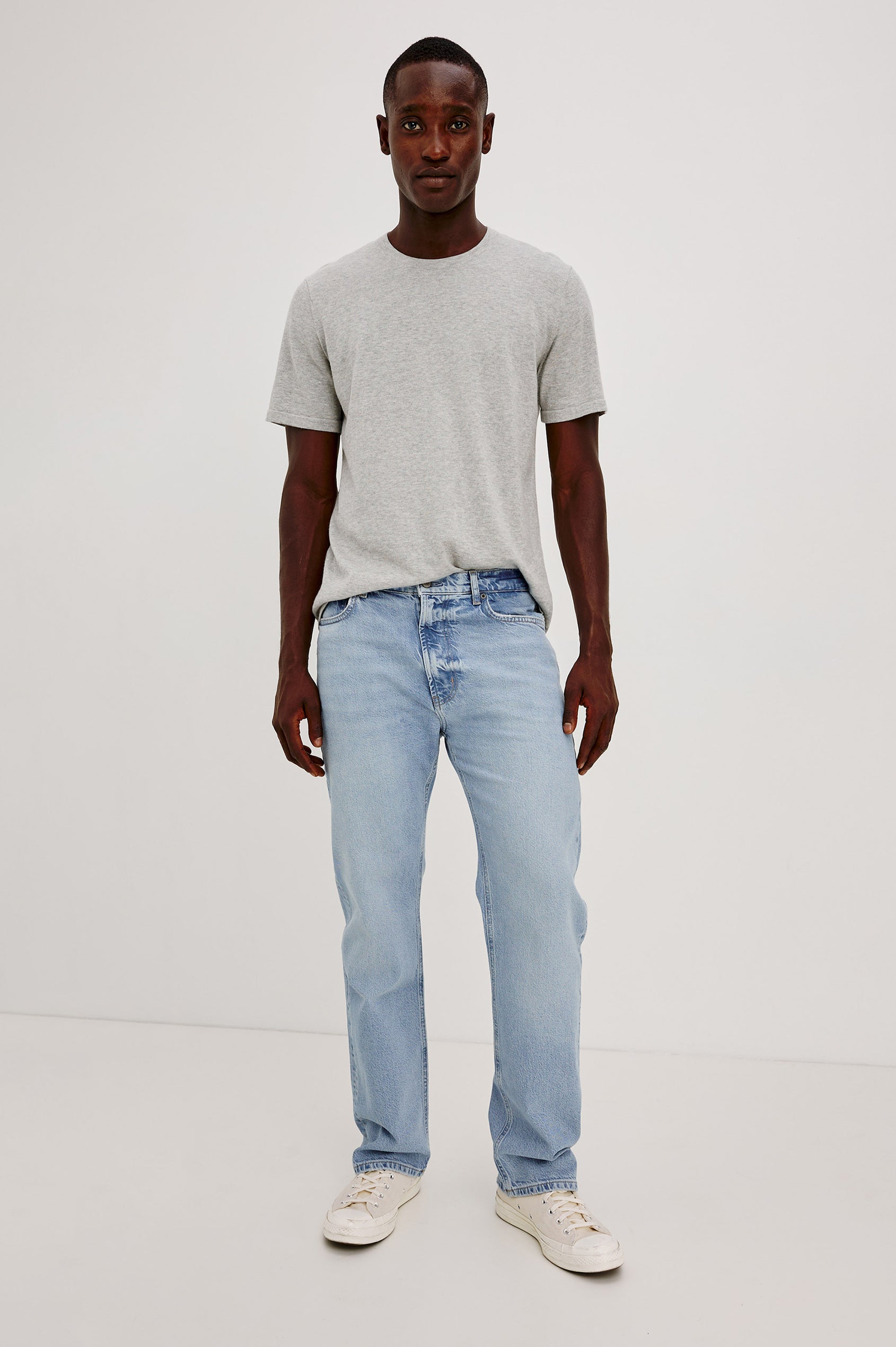 Nash is a straight leg 5-Pocket denim jean a zip fly and button closure as well as rivets in a Ranchwater Wash. Front view featured on model.