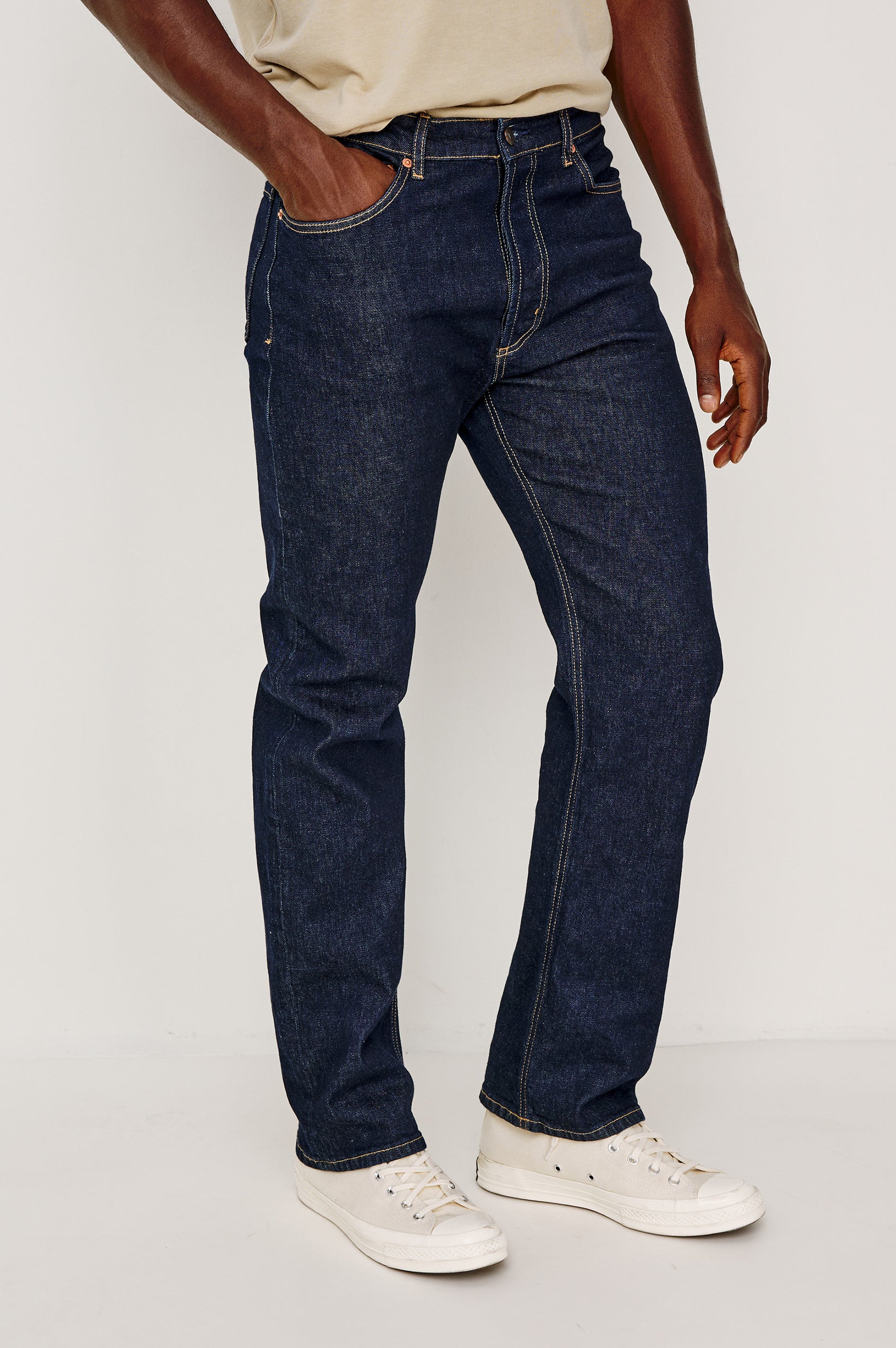 Nash is a straight leg 5-Pocket denim jean a zip fly and button closure as well as rivets in a Rinse Wash. Front view featured on model.