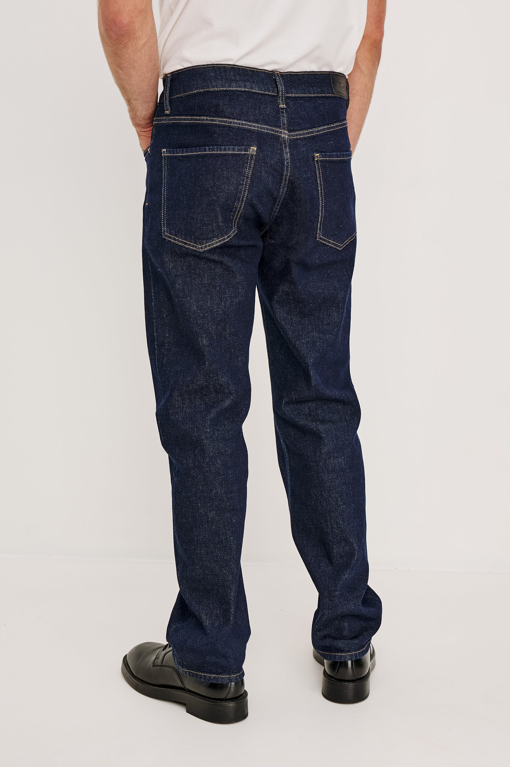 Nash is a straight leg 5-Pocket denim jean a zip fly and button closure as well as rivets in a Rinse Wash. Front view featured on model.