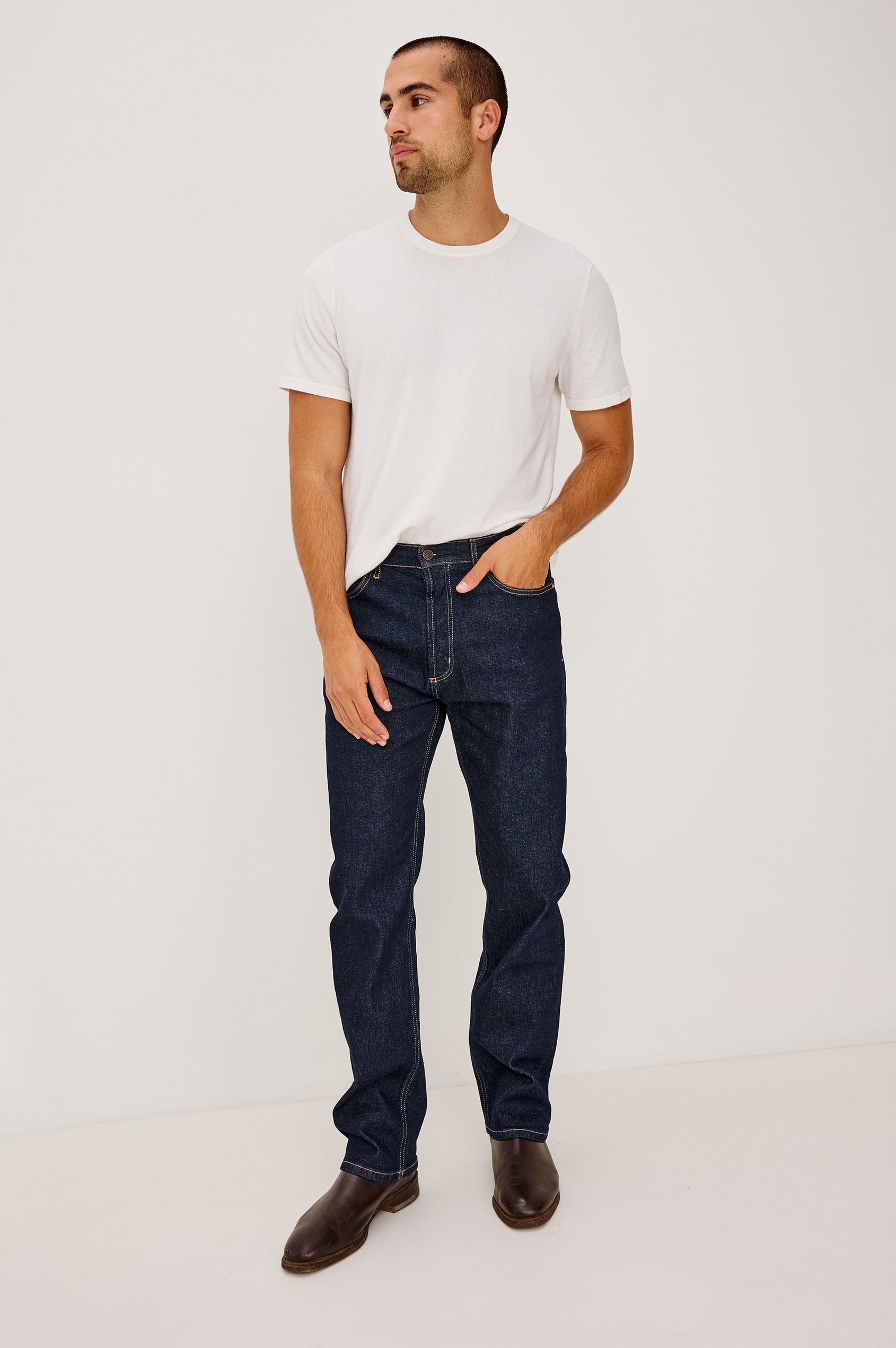 Nash is a straight leg 5-Pocket denim jean a zip fly and button closure as well as rivets in a Rinse Wash. Front full body view featured on model.