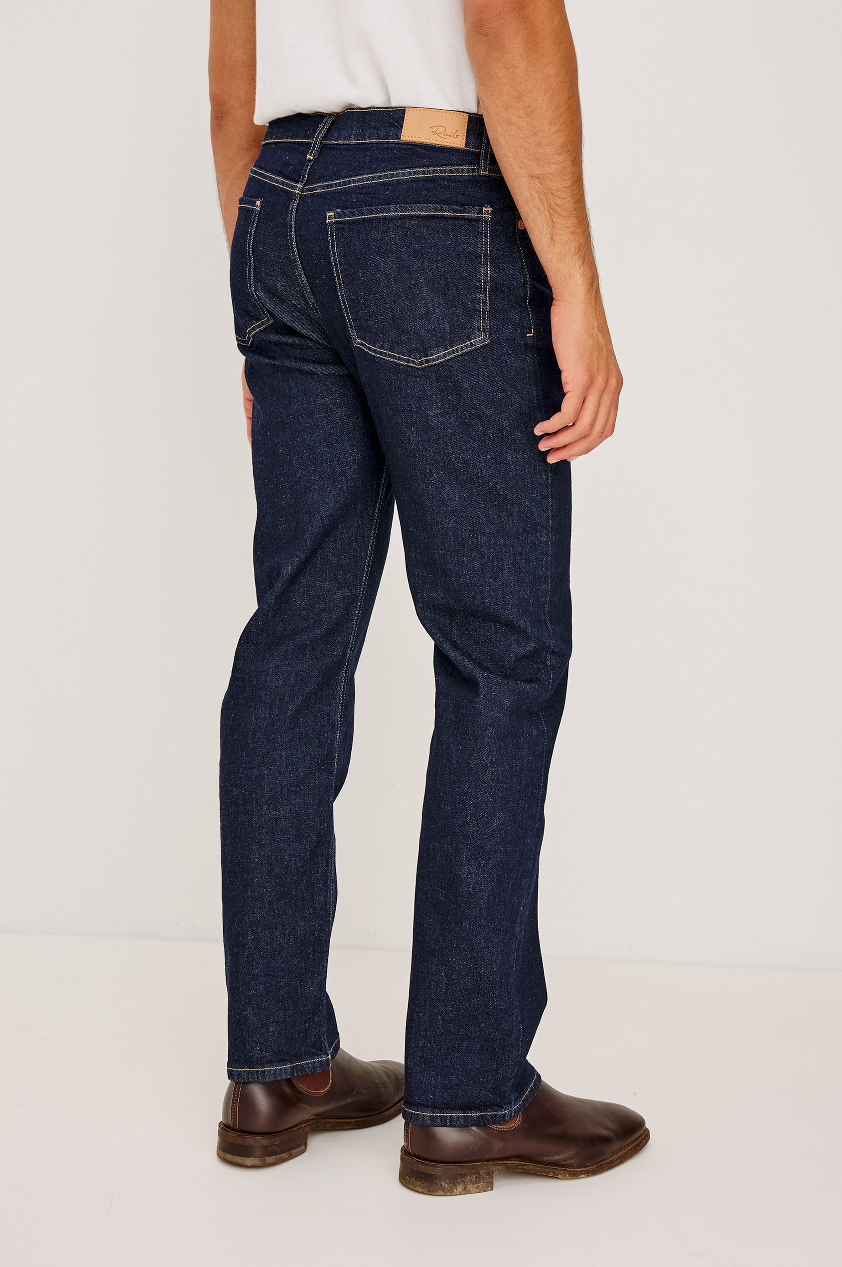 Nash is a straight leg 5-Pocket denim jean a zip fly and button closure as well as rivets in a Rinse Wash. Front view featured on model.
