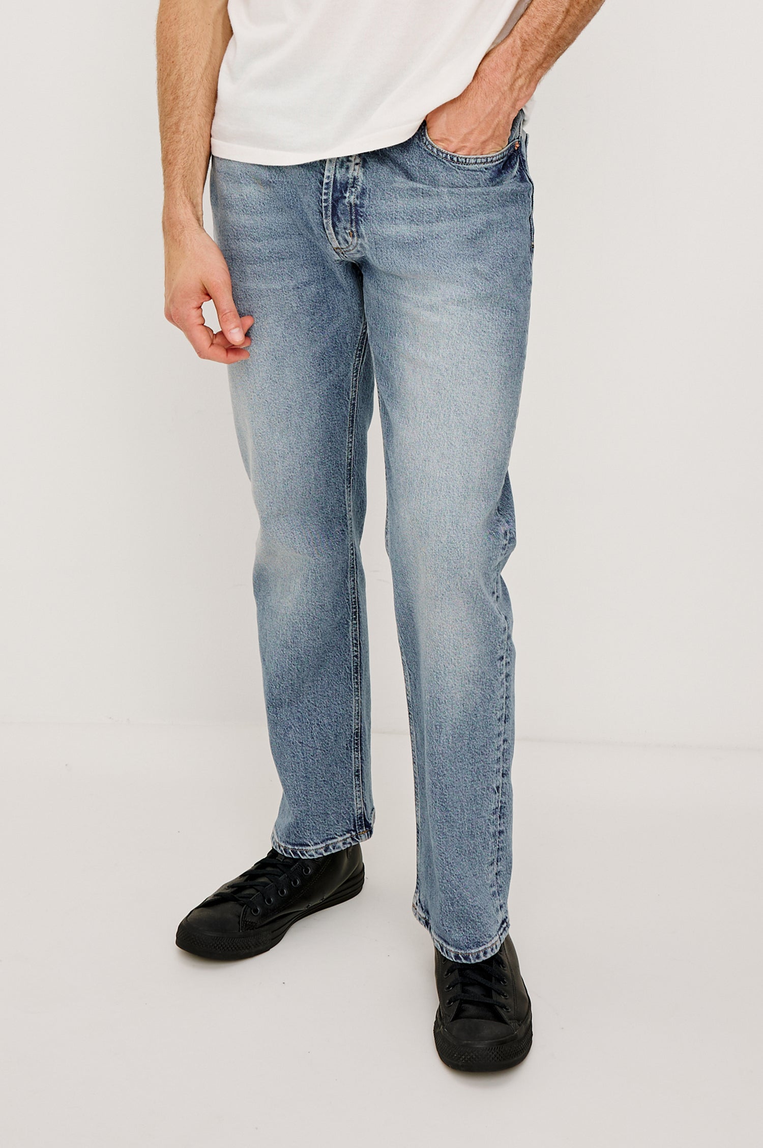 Nash is a straight leg 5-Pocket denim jean a zip fly and button closure as well as rivets in a Medium Vintage Wash. Front view featured on model.