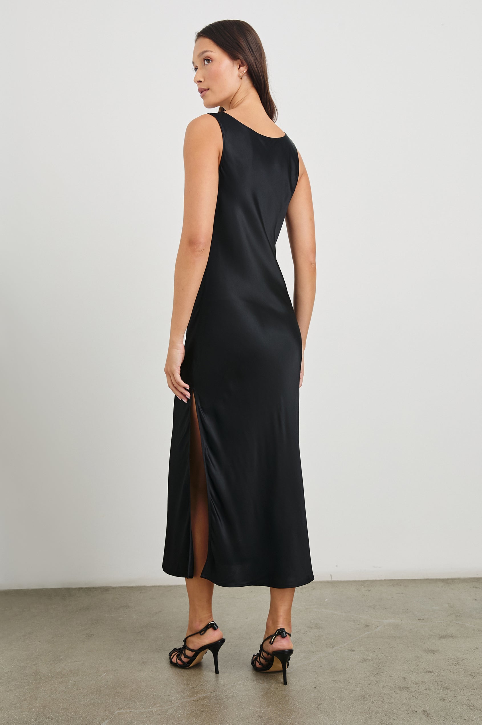Nat Sleeveless Midi Dress with a Cowl Neck and Mid-Thigh Side Slit in Black Colorway - Back Full Body View Featured on Model