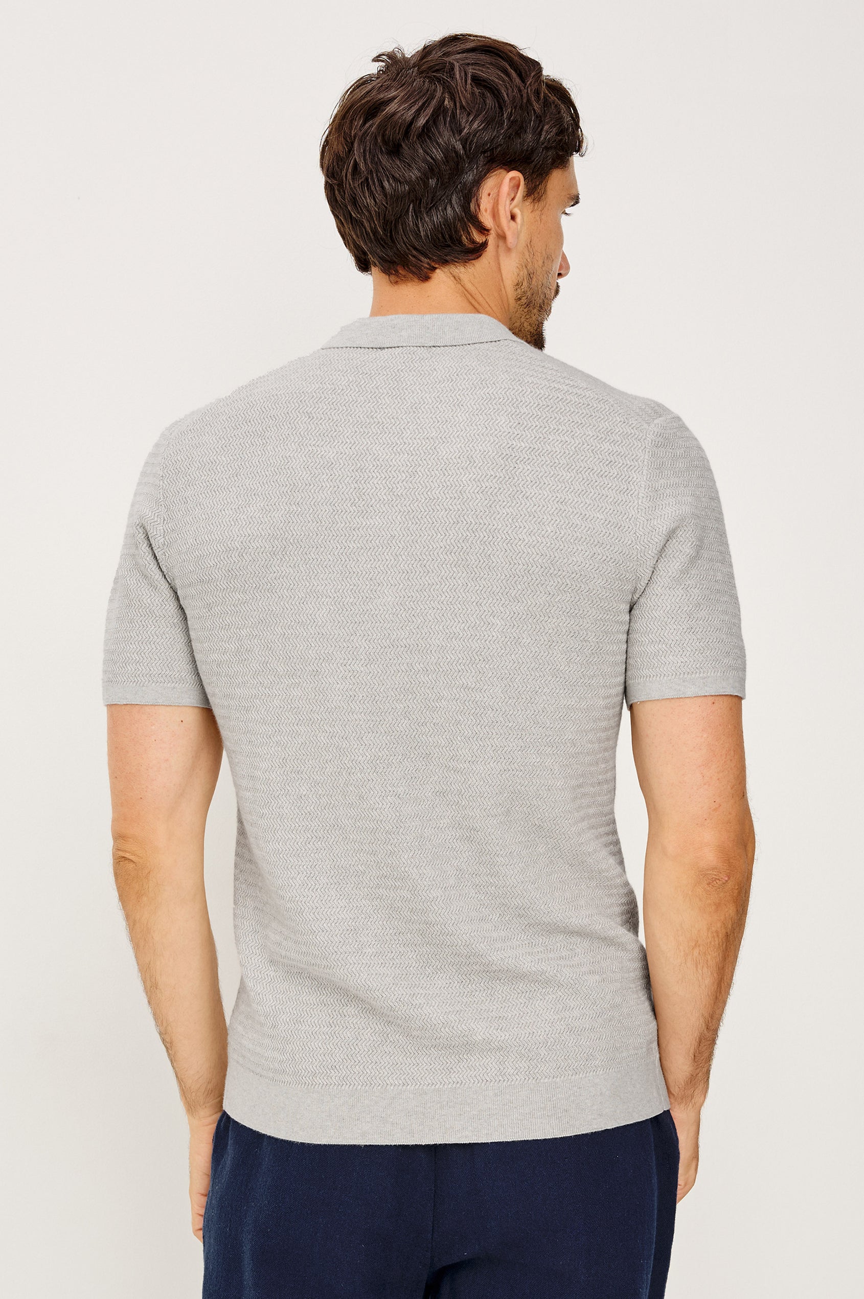 Nathan Polo Shirt in Cotton Blend Knit With Collar, Quarter Button Placket, and Short Sleeves in Heather Grey Colorway - Upper Body Back View Featured on Model