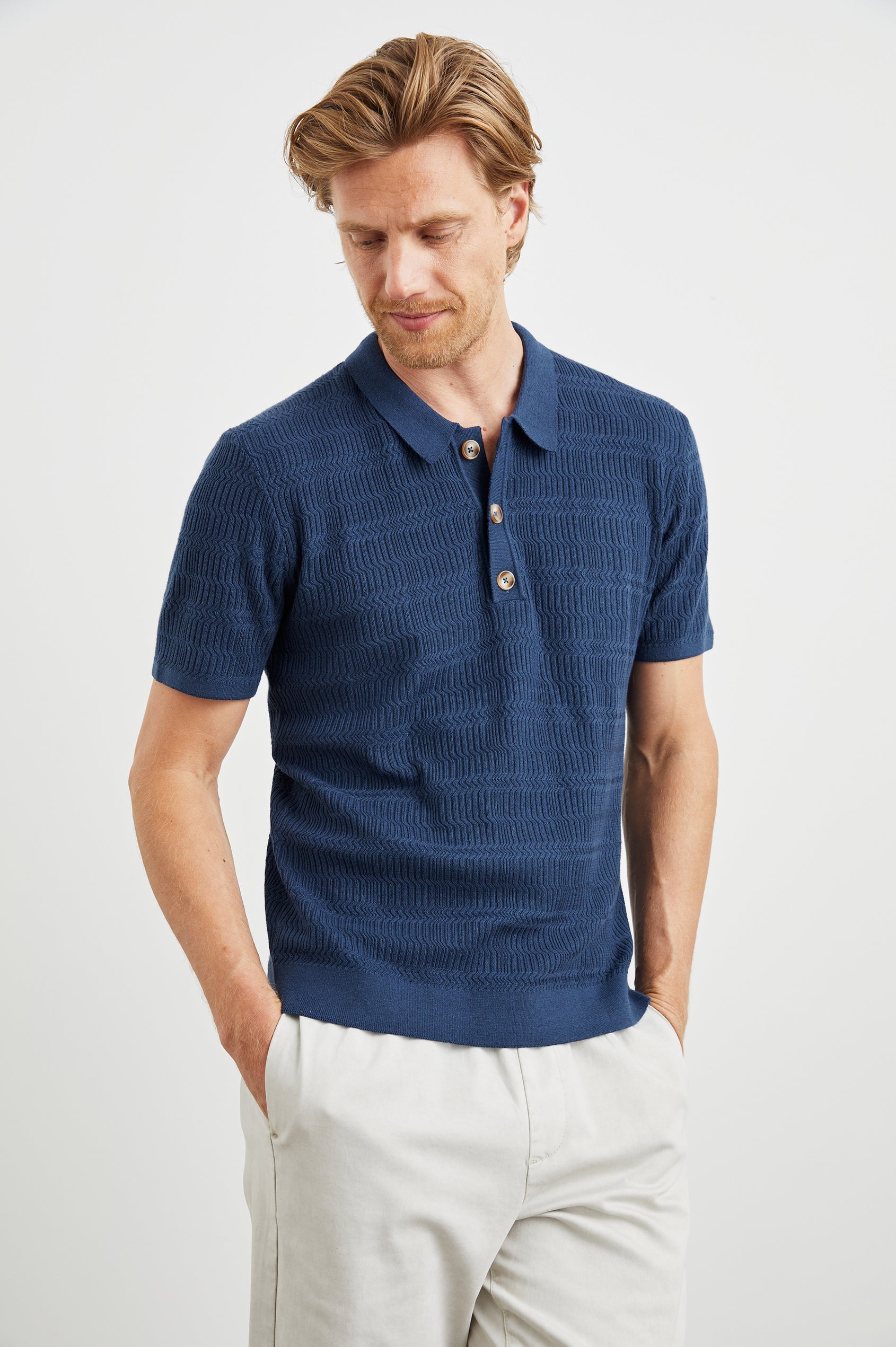 Nathan Short-Sleeve Polo Shirt with a Three-Button Placket and a Jacquard Pattern in Peterson Blue Colorway - Front View Featured on Model