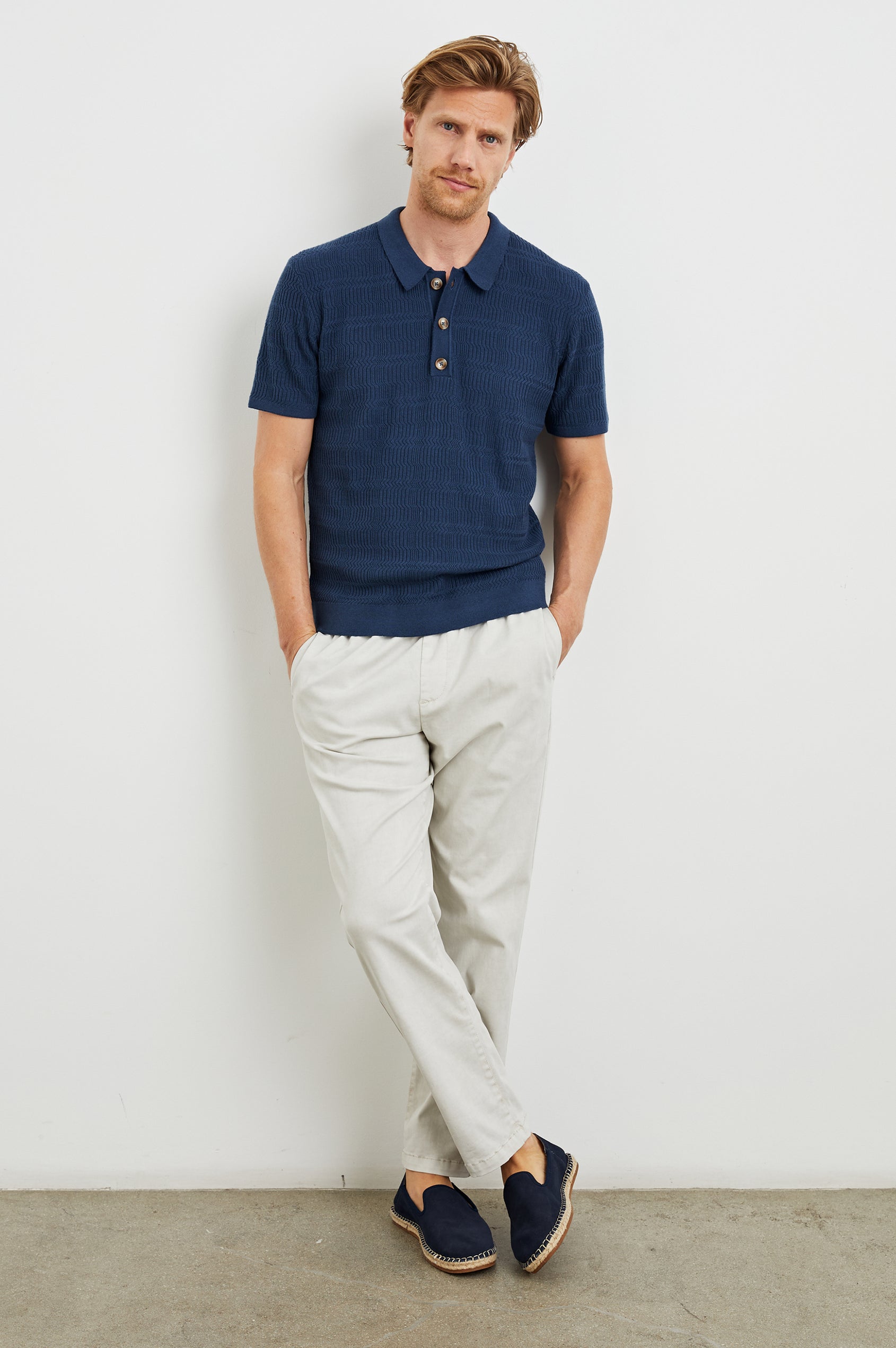 Nathan Short-Sleeve Polo Shirt with a Three-Button Placket and a Jacquard Pattern in Peterson Blue Colorway - Front Full Body View Featured on Model