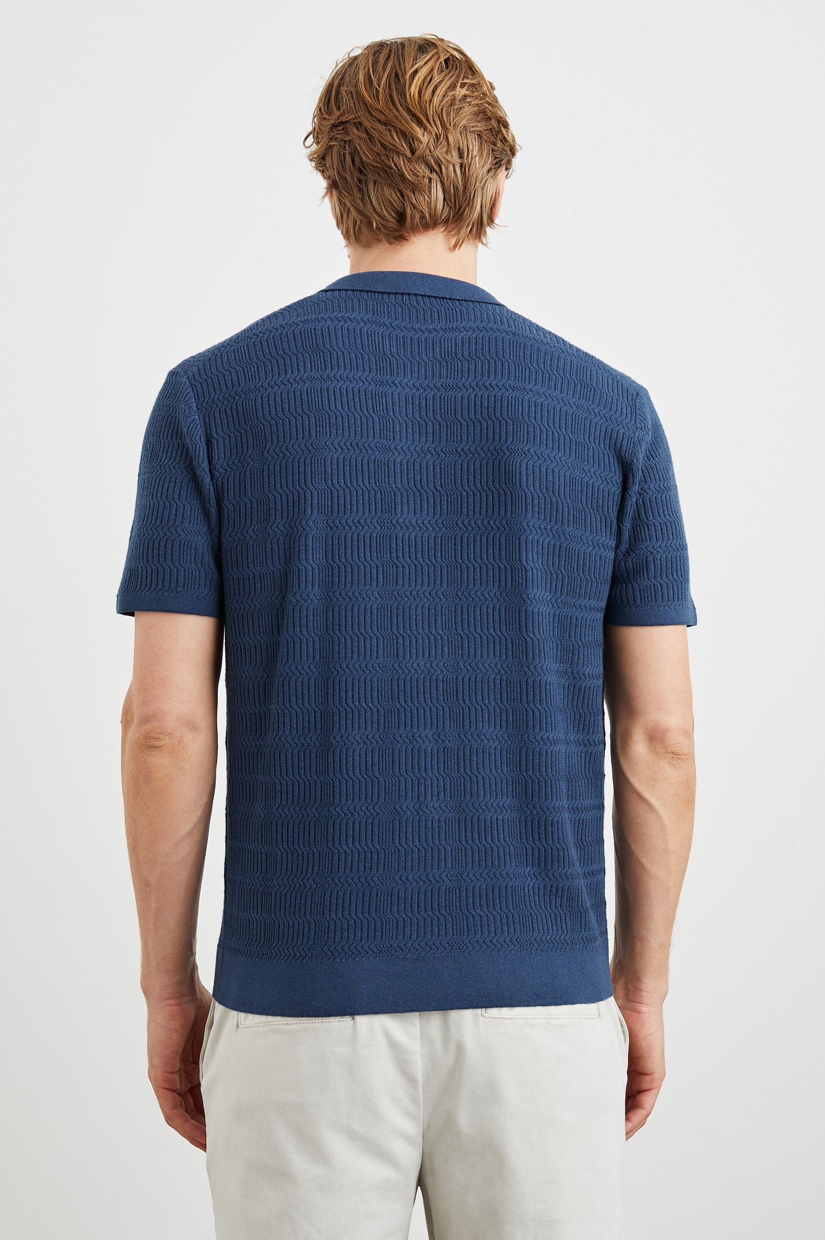 Nathan Short-Sleeve Polo Shirt with a Three-Button Placket and a Jacquard Pattern in Peterson Blue Colorway - Back View Featured on Model
