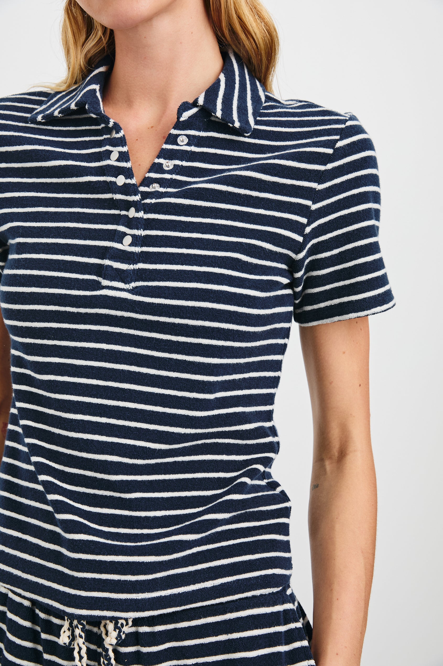 Naveli Court Polo with a Button-Up Placket in Navy Ivory Stripe Colorway, Horizontal Stripes - Front View Featured on Model