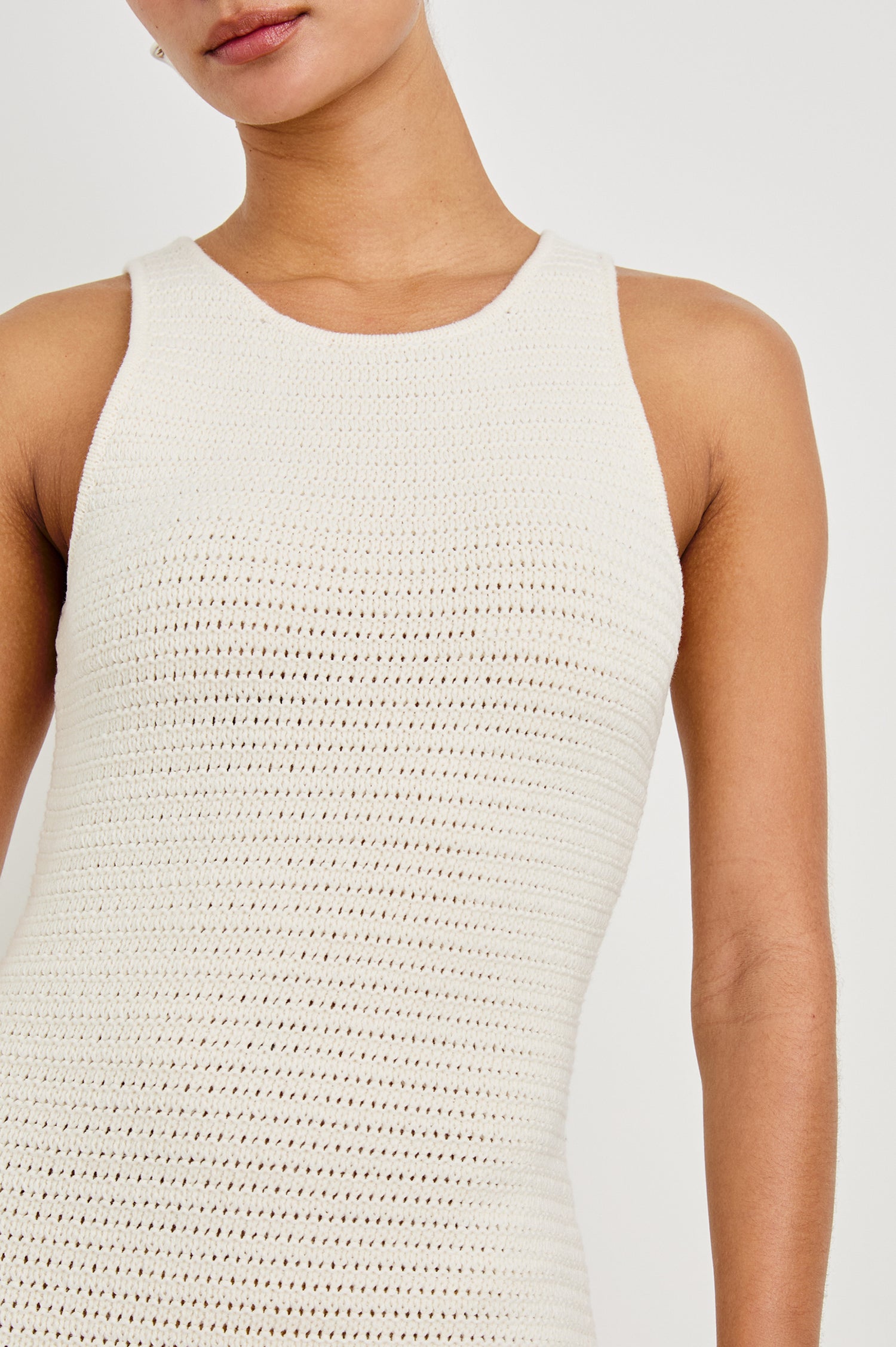 Close up detail shot of female model wearing our sleeveless, Nia Midi Dress in color Ecru, featuring crochet structure and thick straps.